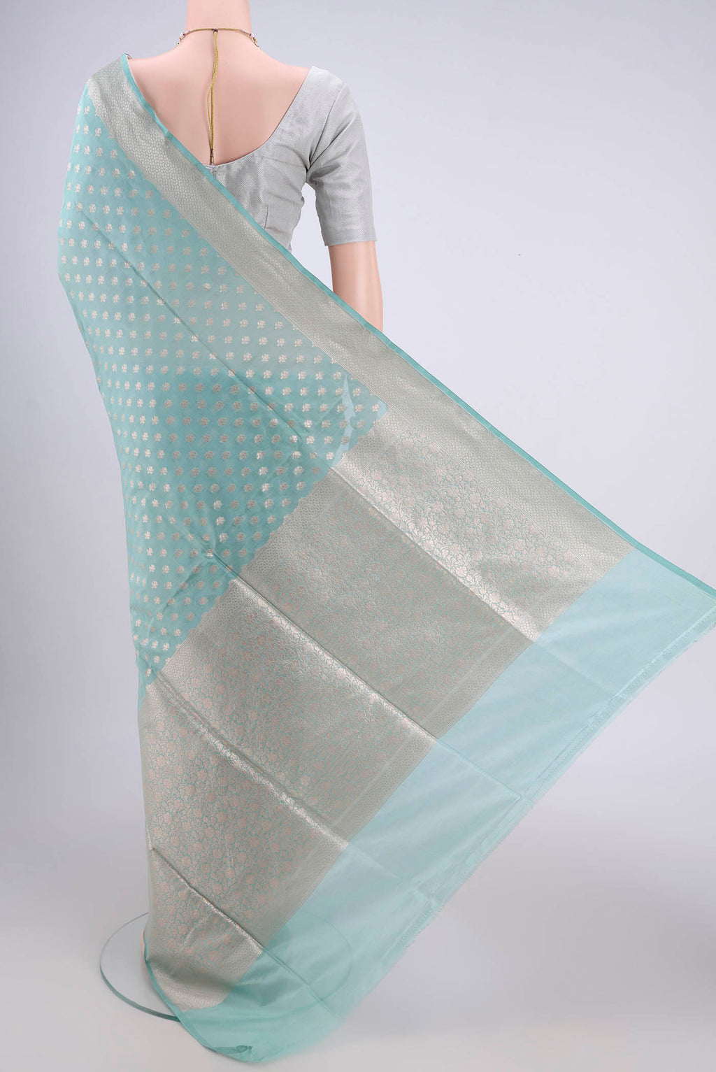 Flat view of Sky Blue Banarasi Silk Saree with Zari Butta on the body and Zari Border. 