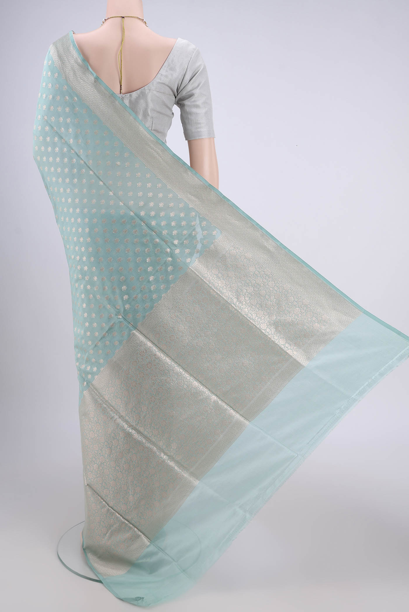 Flat view of Sky Blue Banarasi Silk Saree with Zari Butta on the body and Zari Border. 