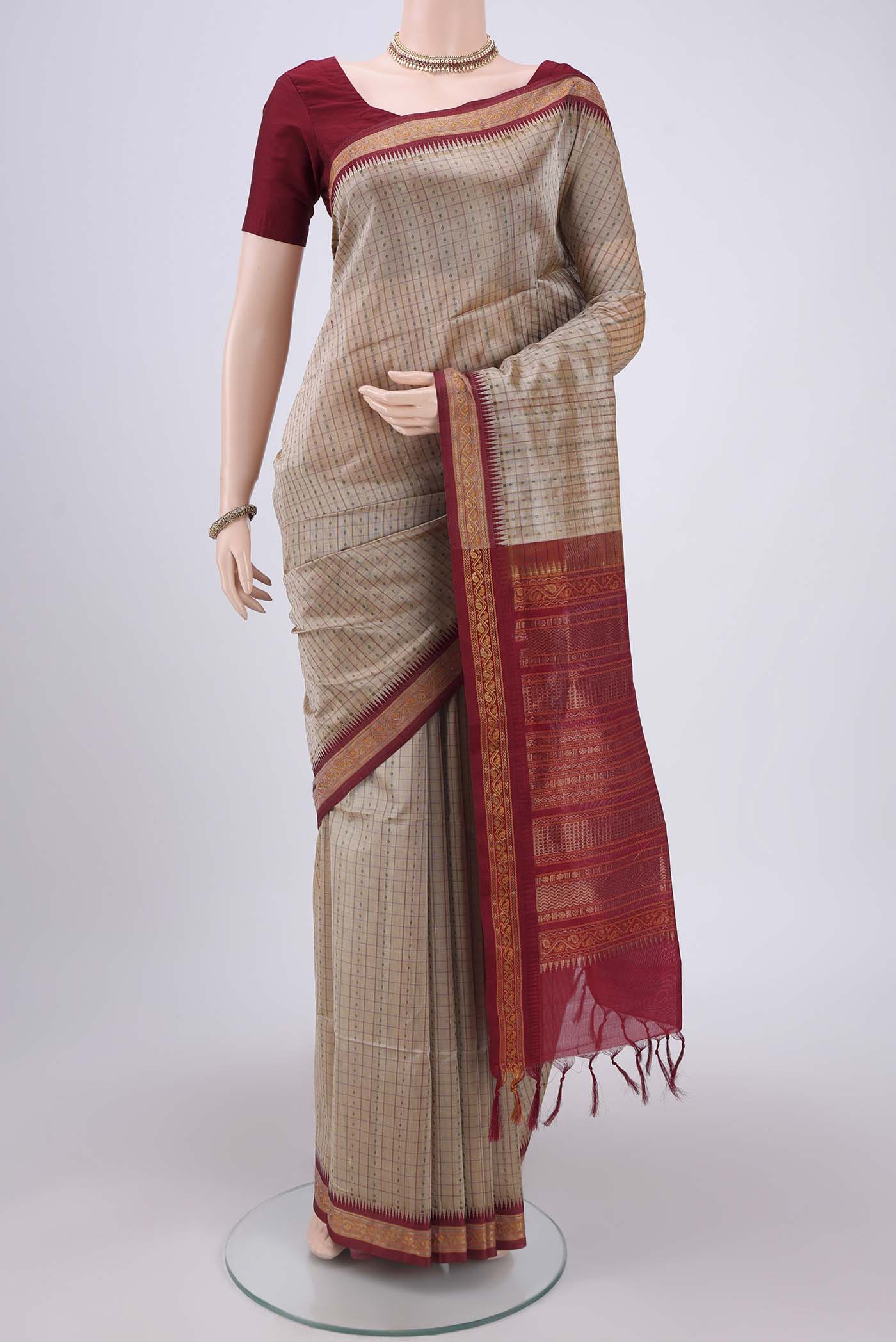 Beige Silk Cotton Saree with Checked design on the body and Zari And Thread Border.  displayed on a mannequin