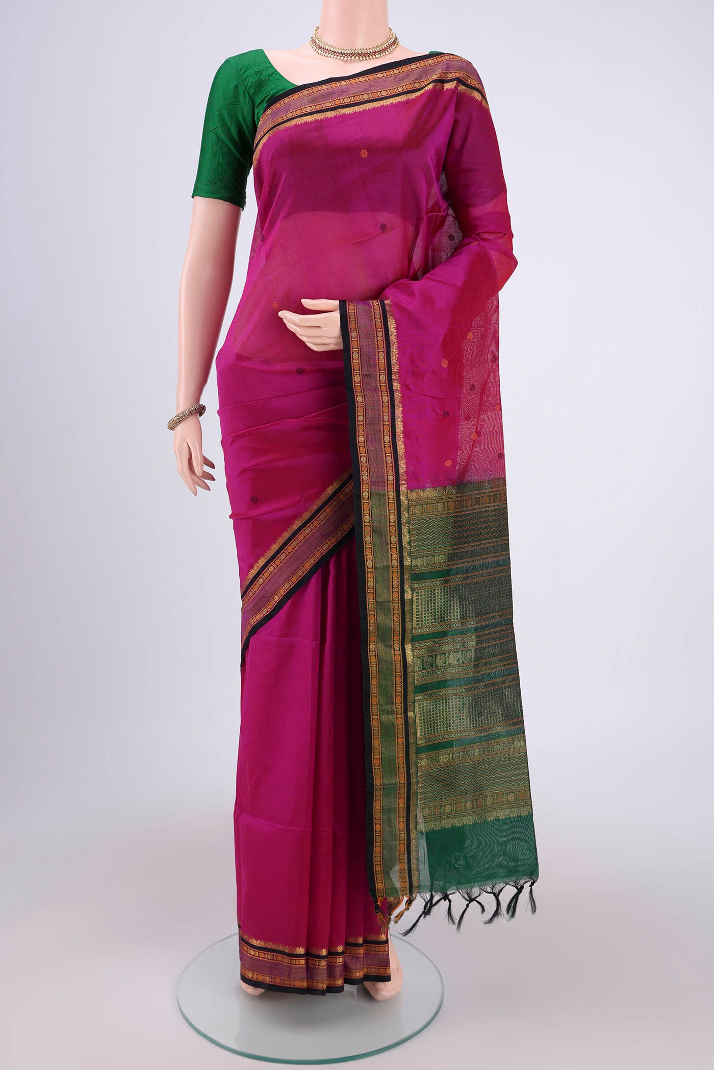 Rani Pink Silk Cotton Saree with Thread Butta on the body and Zari And Thread Border.  displayed on a mannequin