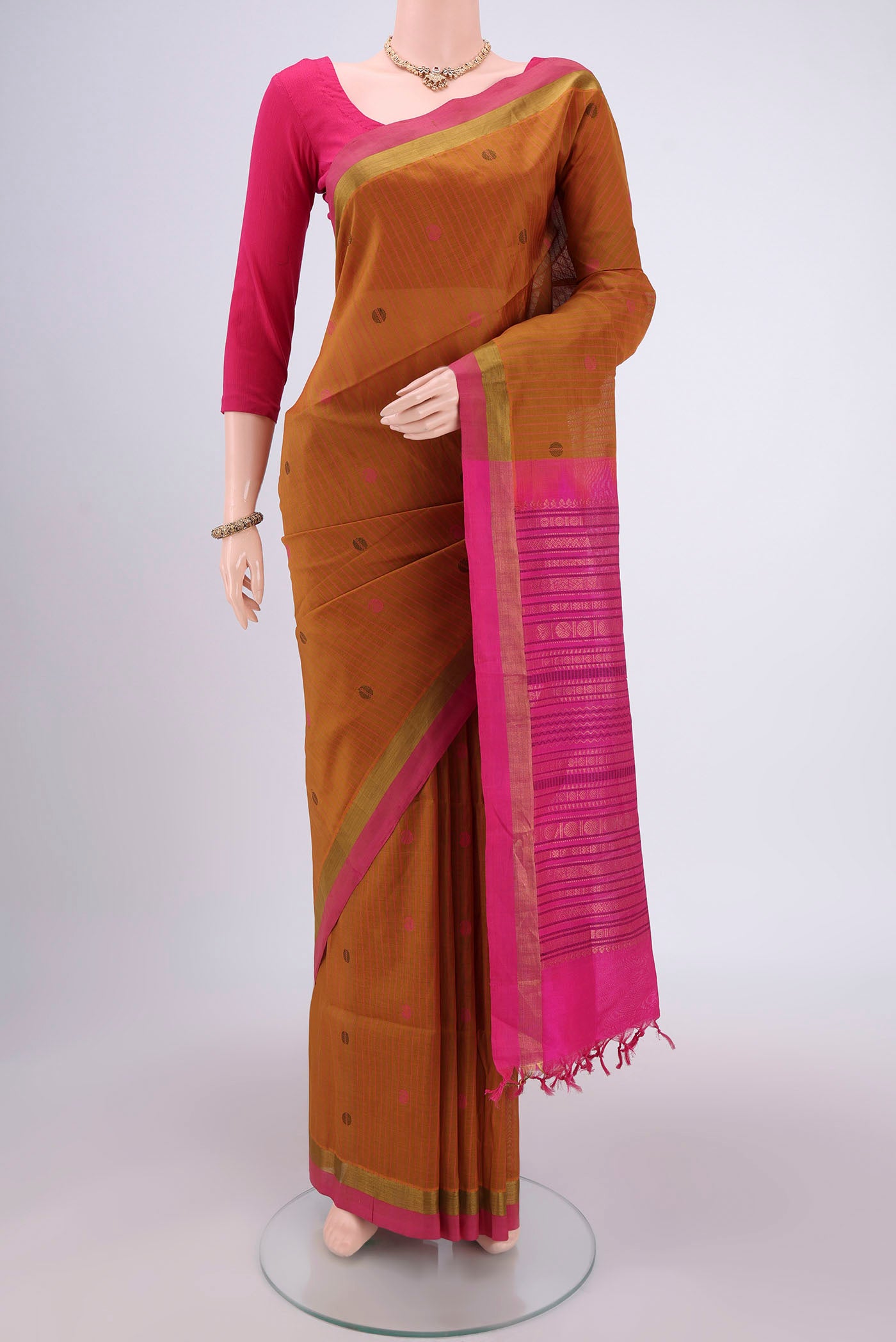 Mustard Coimbatore Silk Cotton Saree with Stripes on the body and Plain Border.  displayed on a mannequin