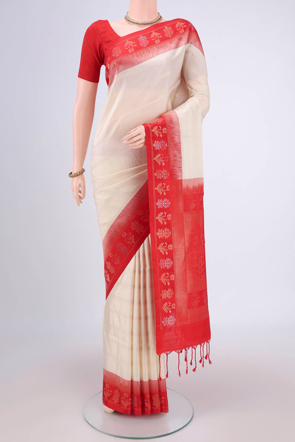 Off White Soft Silk Saree with Stripes on the body and Zari Border.  displayed on a mannequin