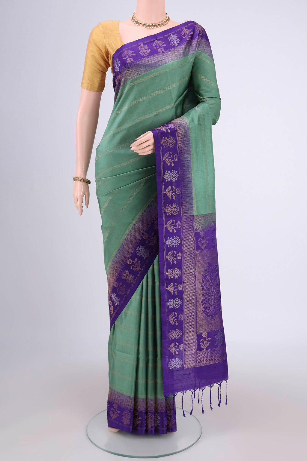 Sage Green Soft Silk Saree with Stripes on the body and Zari Border.  displayed on a mannequin