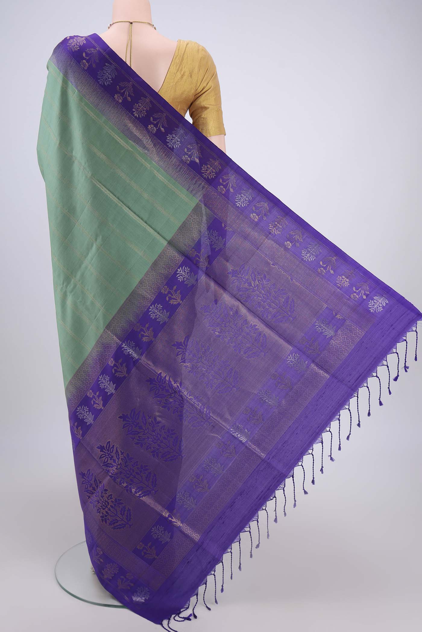 Flat view of Sage Green Soft Silk Saree with Stripes on the body and Zari Border. 