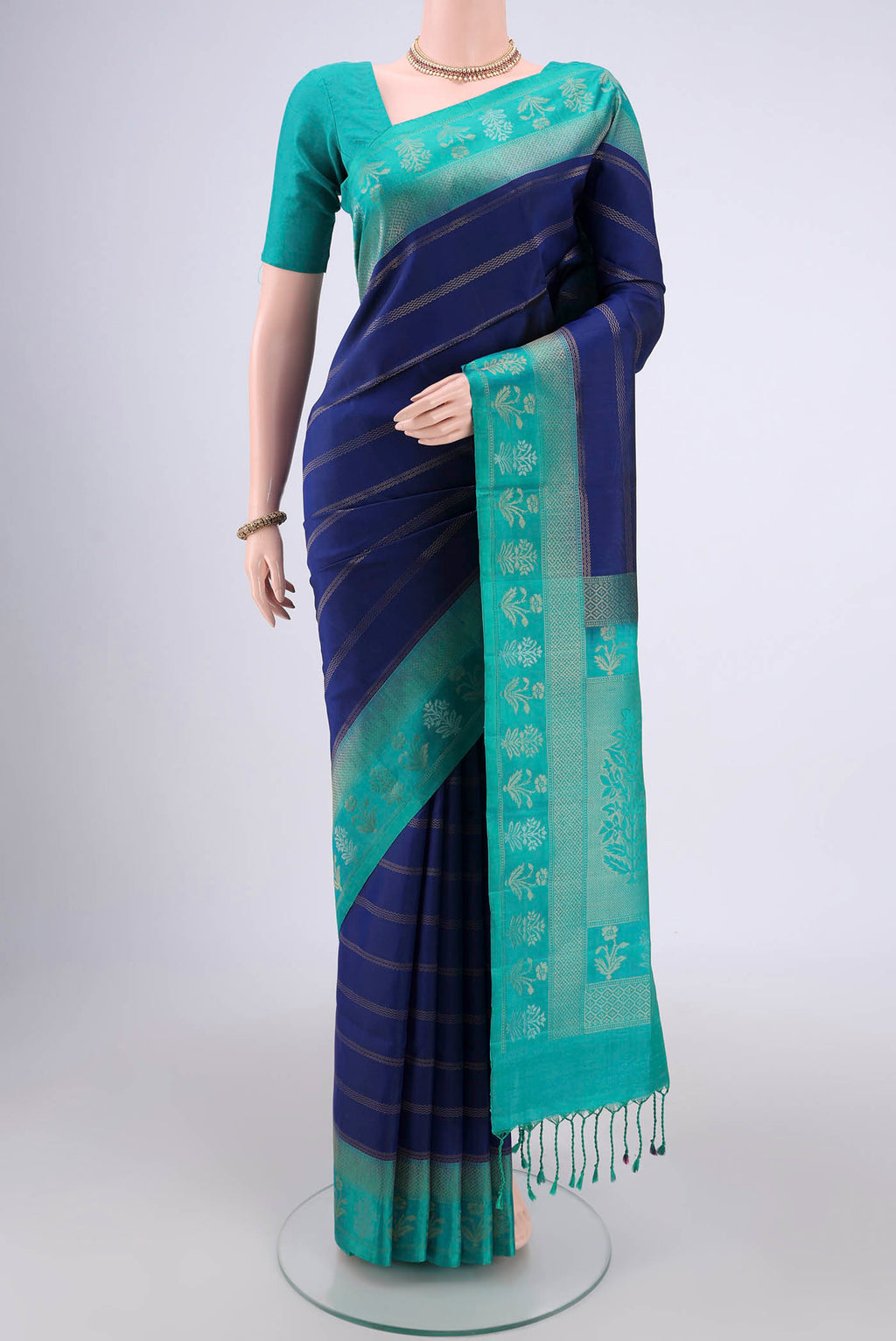 Navy Blue Soft Silk Saree with Stripes on the body and Zari Border.  displayed on a mannequin