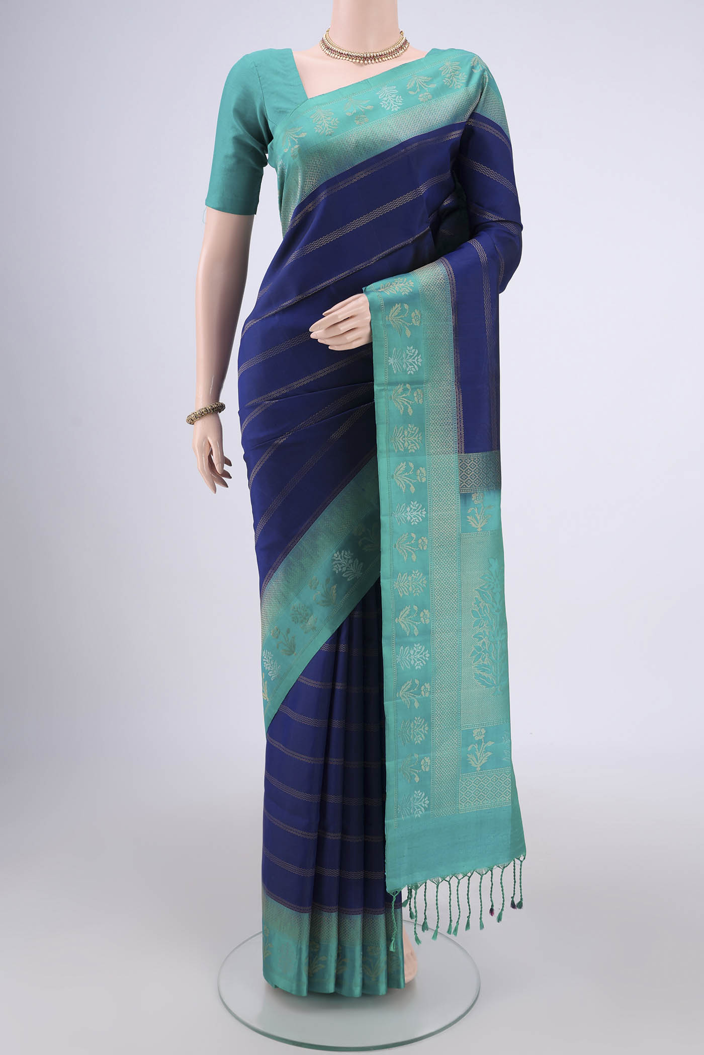 Navy Blue Soft Silk Saree with Stripes on the body and Zari Border.  displayed on a mannequin
