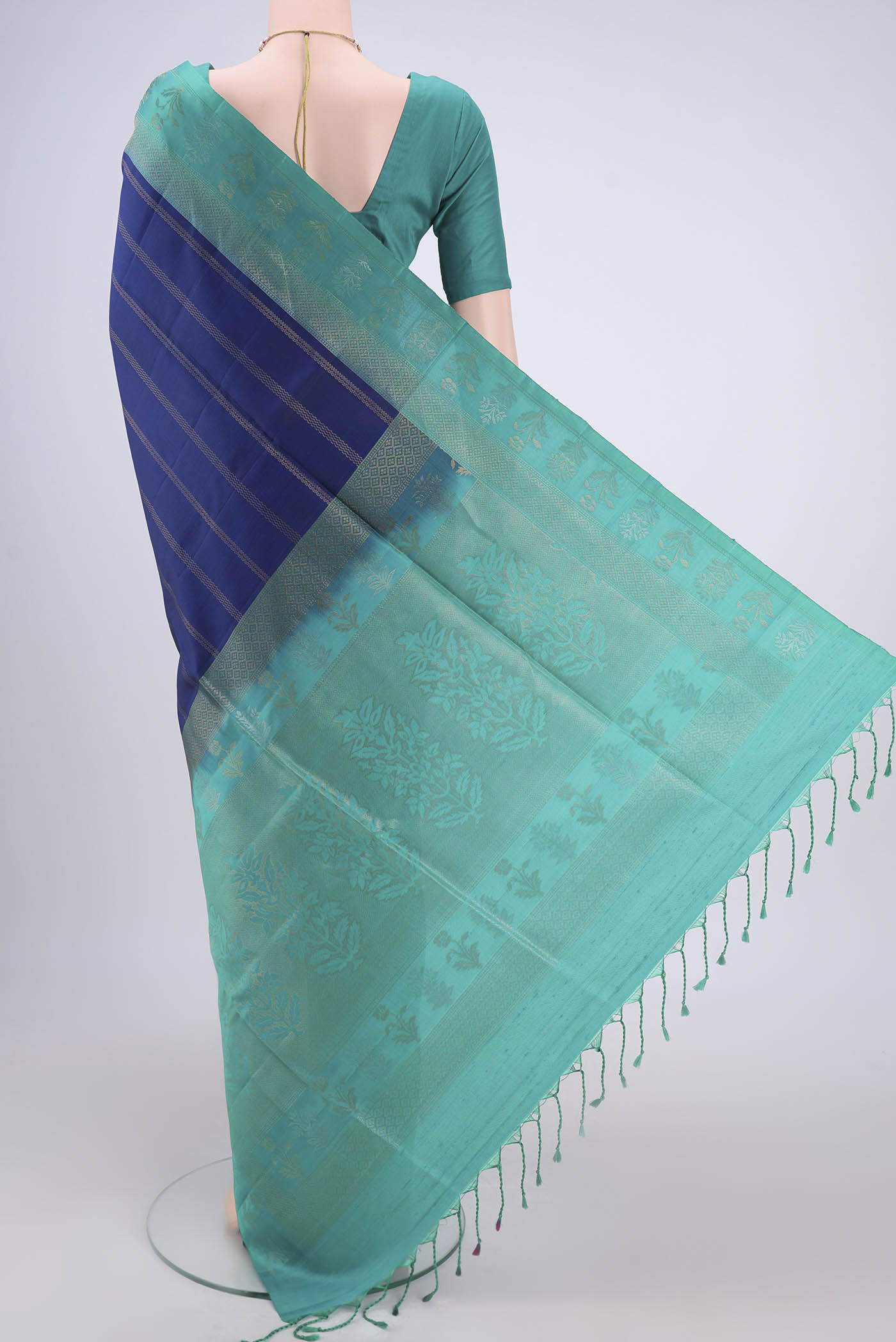 Flat view of Navy Blue Soft Silk Saree with Stripes on the body and Zari Border. 