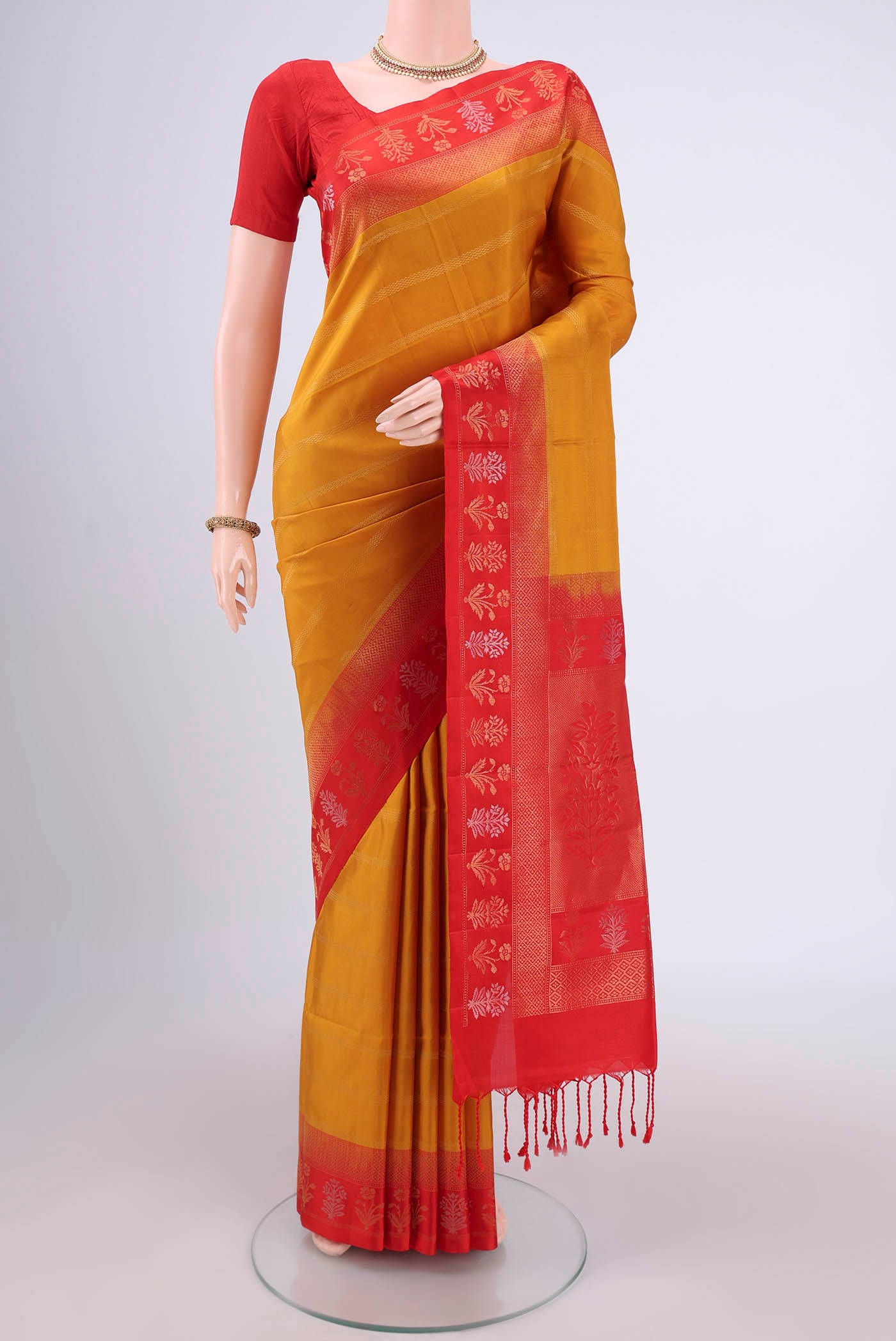 Mustard Soft Silk Saree with Stripes on the body and Zari Border.  displayed on a mannequin