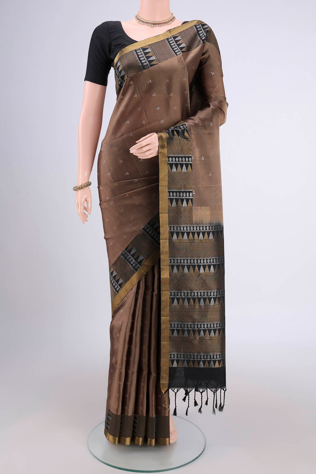Brown Soft Silk Saree with Zari Butta on the body and Zari Border.  displayed on a mannequin