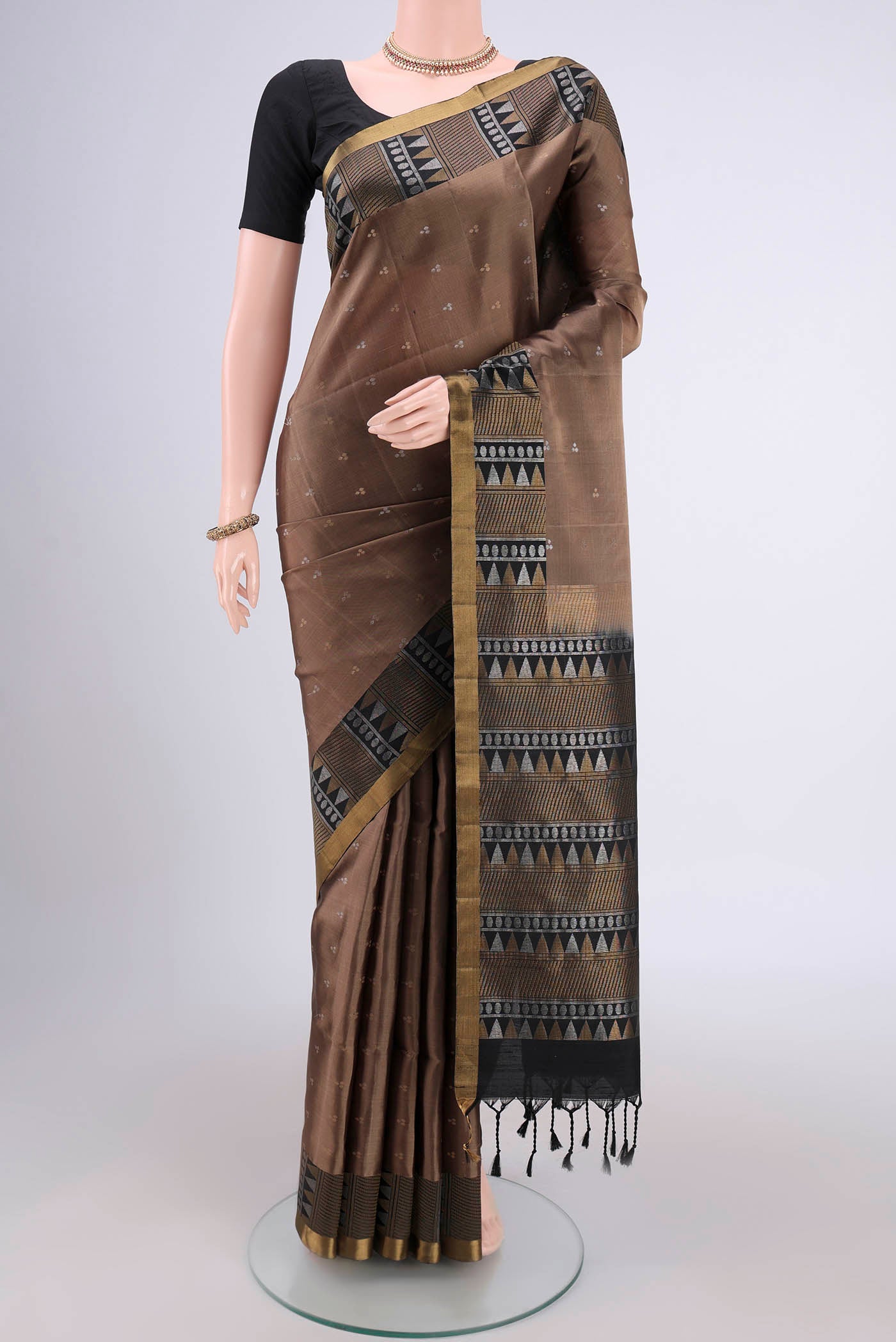 Brown Soft Silk Saree with Zari Butta on the body and Zari Border.  displayed on a mannequin