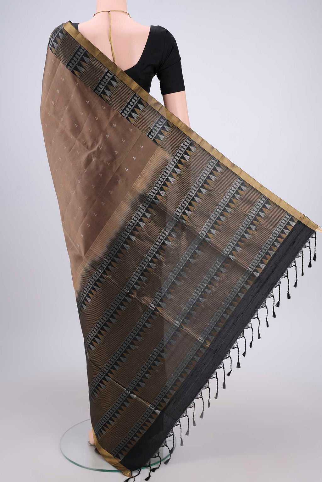 Flat view of Brown Soft Silk Saree with Zari Butta on the body and Zari Border. 