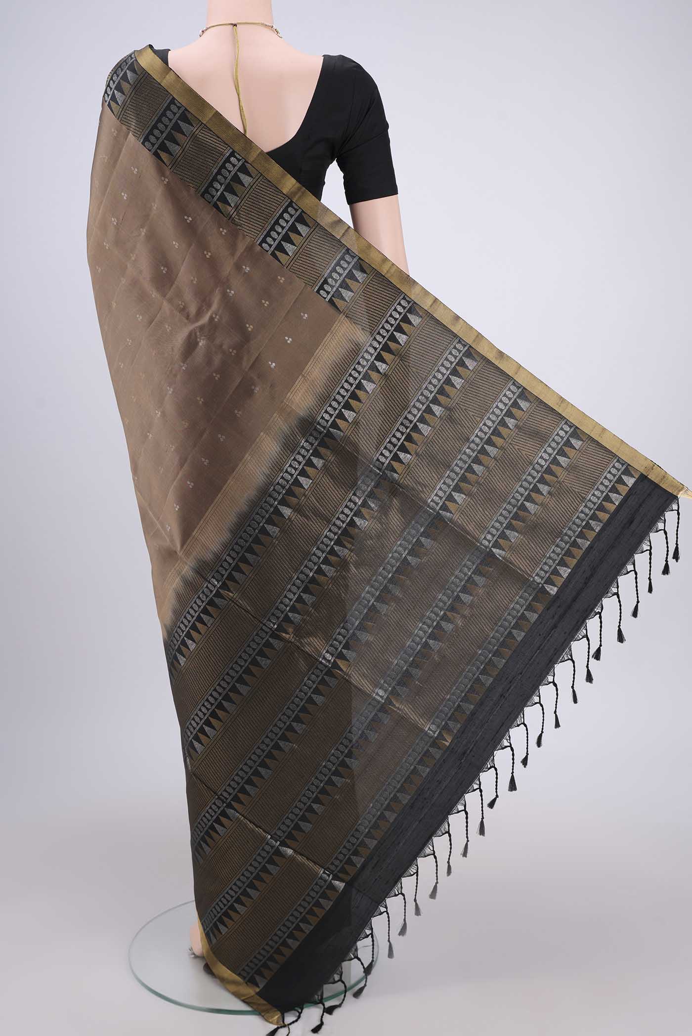 Flat view of Brown Soft Silk Saree with Zari Butta on the body and Zari Border. 