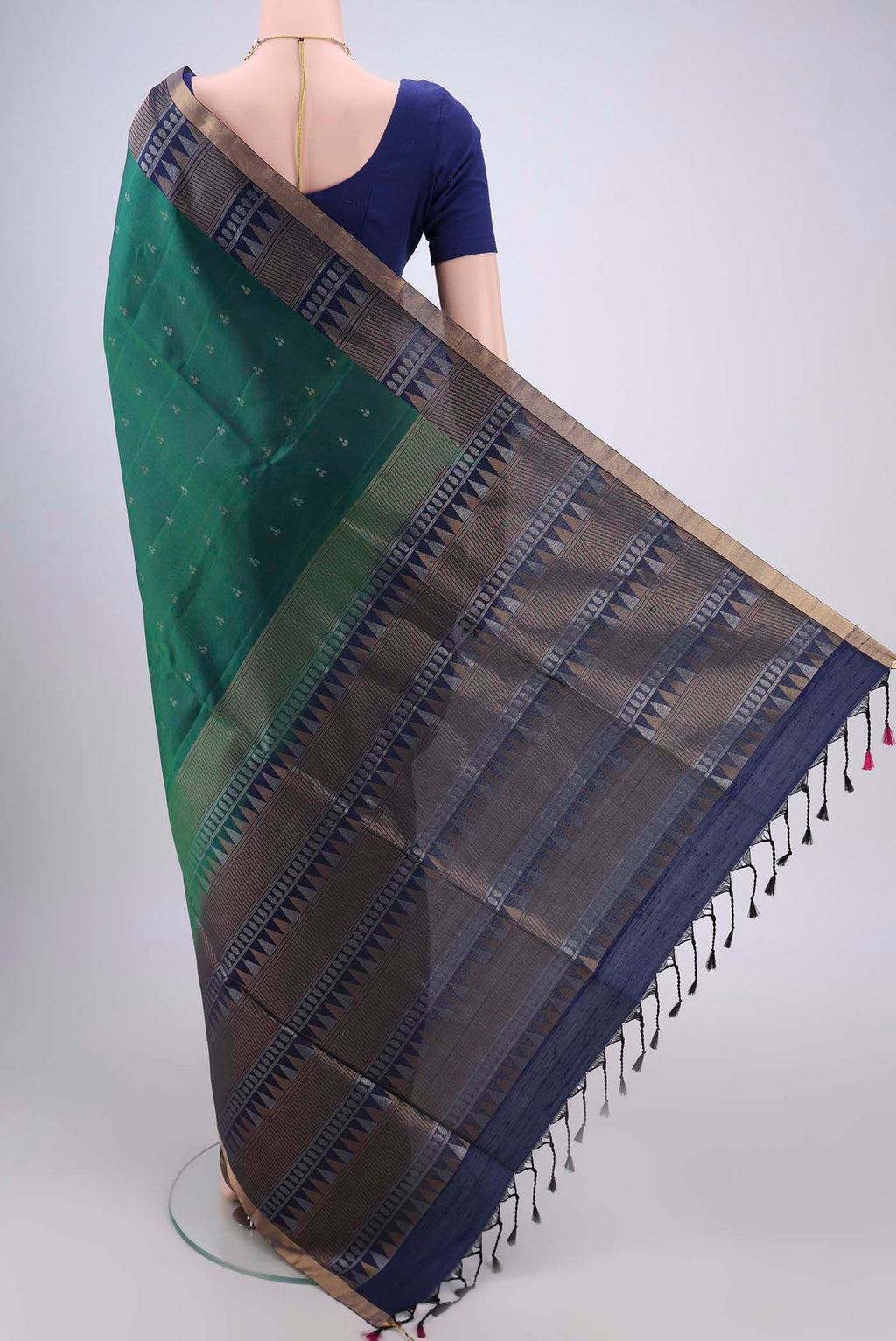 Flat view of Bottle Green Soft Silk Saree with Zari Butta on the body and Zari Border. 