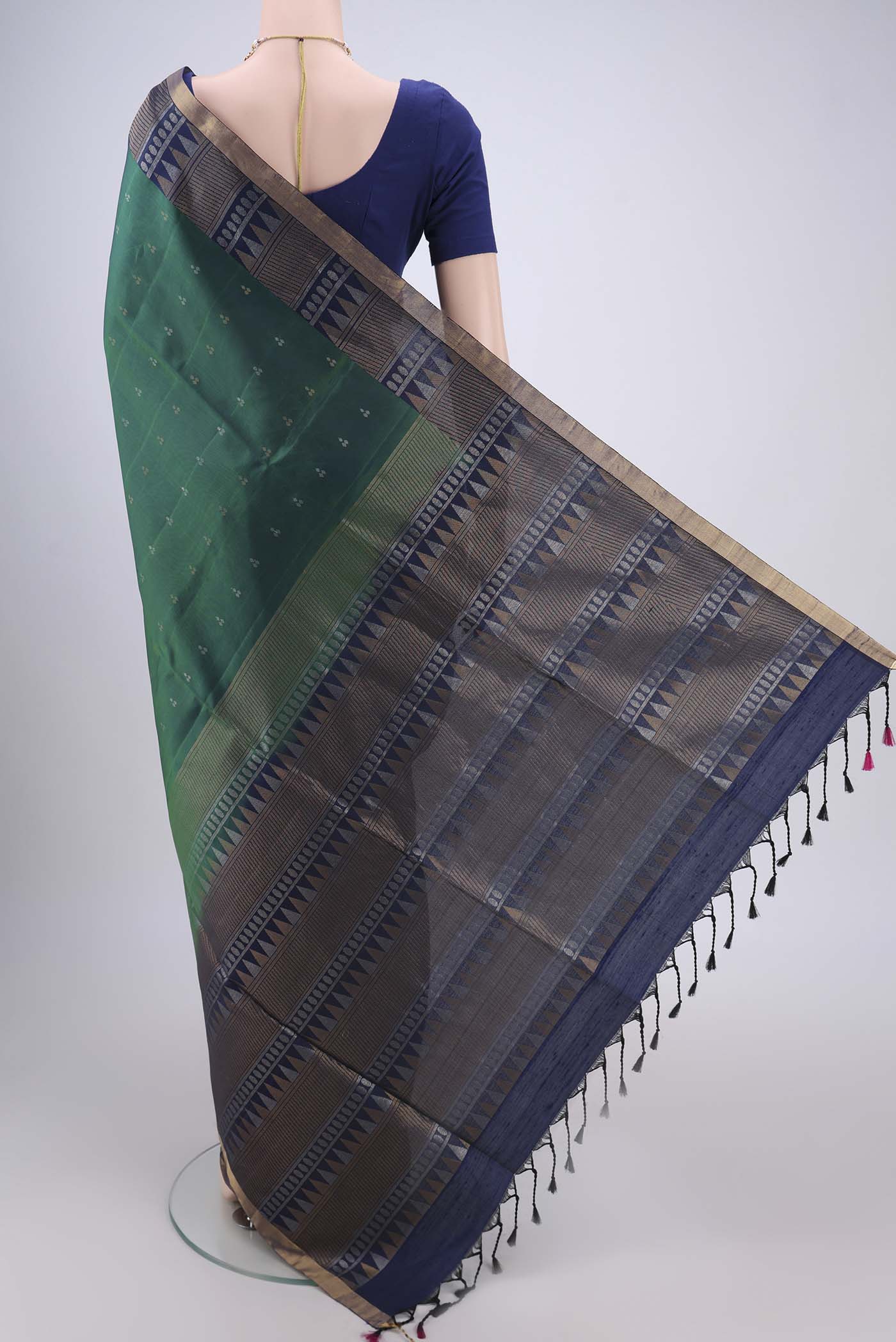 Flat view of Bottle Green Soft Silk Saree with Zari Butta on the body and Zari Border. 