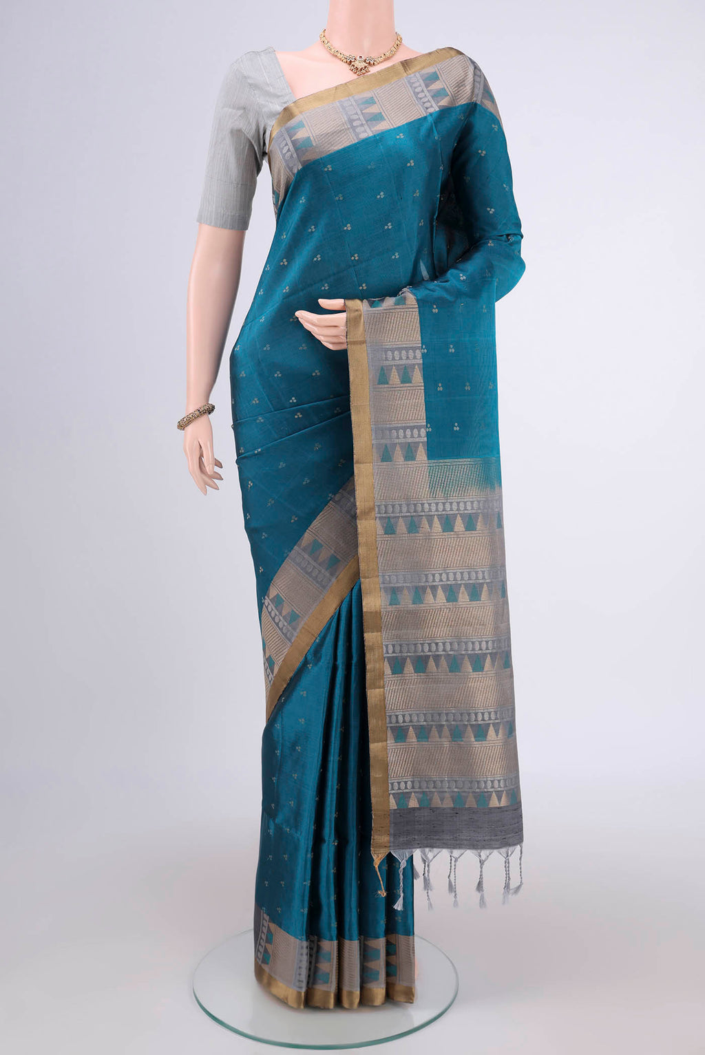 Peacock Blue Soft Silk Saree with Zari Butta on the body and Zari Border.  displayed on a mannequin