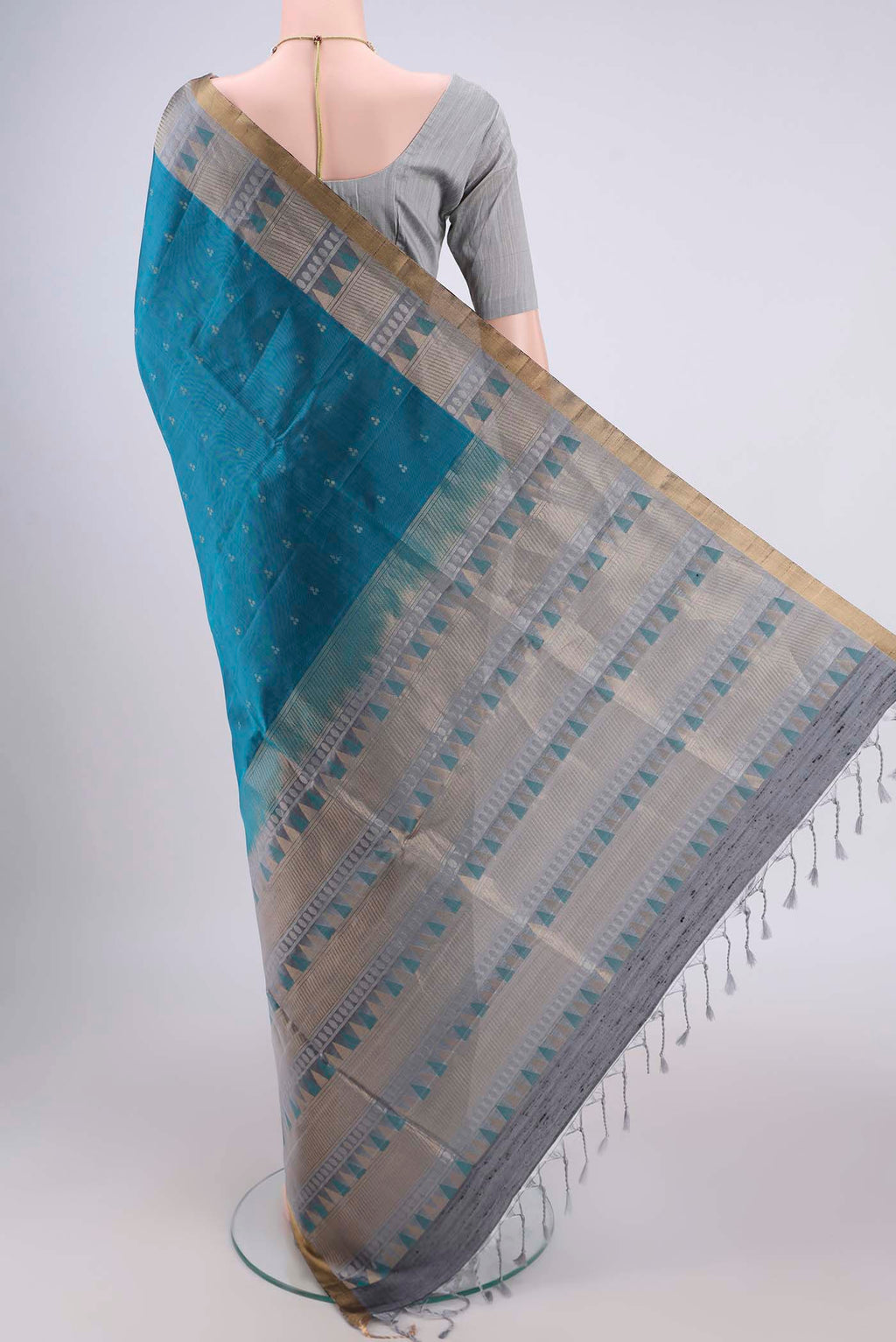 Flat view of Peacock Blue Soft Silk Saree with Zari Butta on the body and Zari Border. 