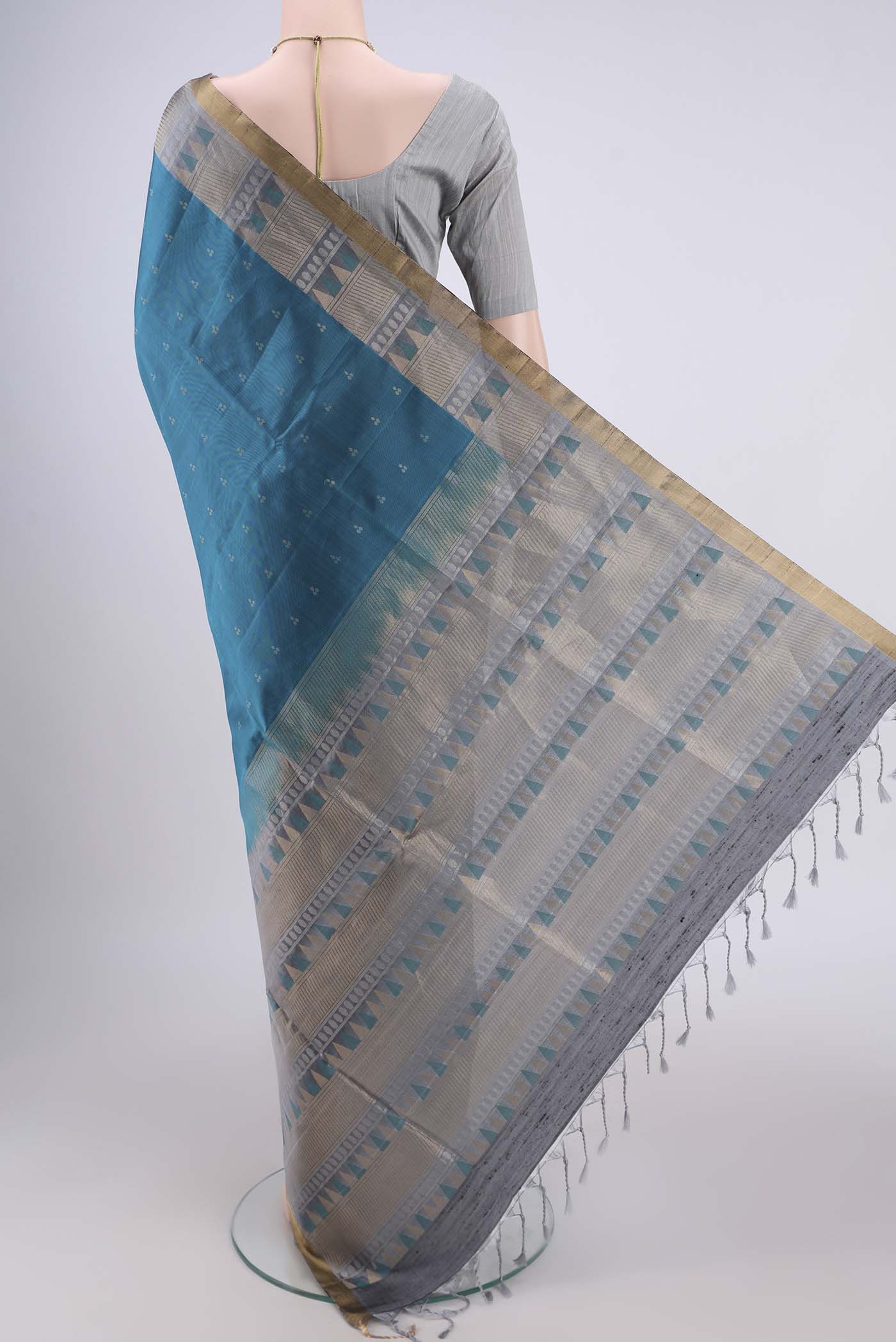 Flat view of Peacock Blue Soft Silk Saree with Zari Butta on the body and Zari Border. 