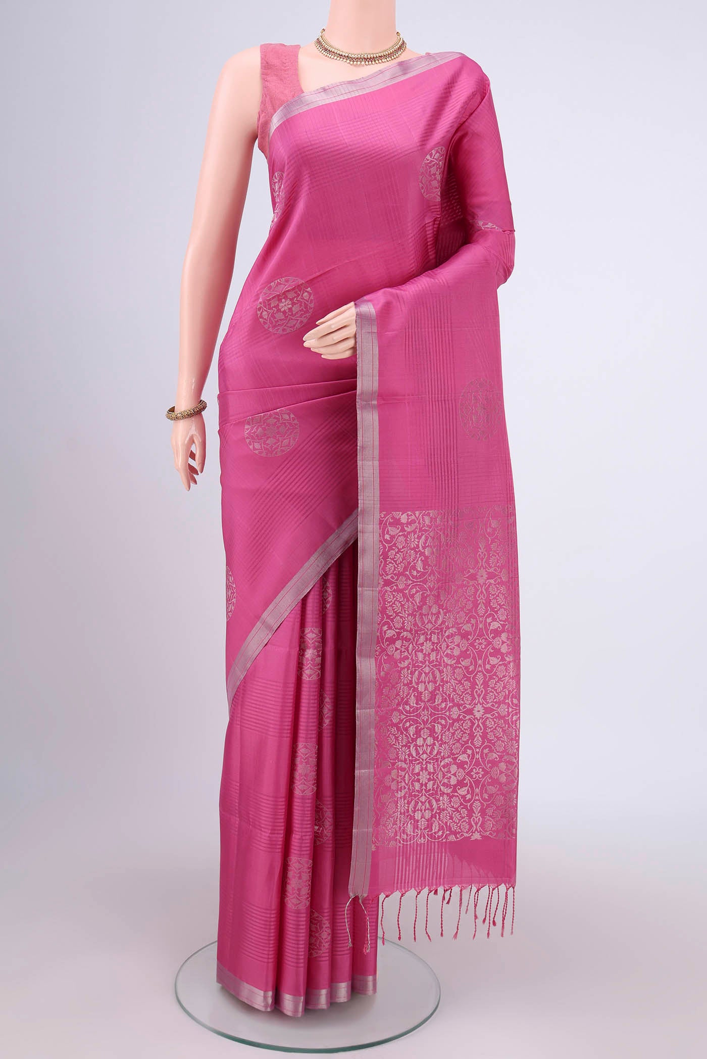 Pink Soft Silk Saree with Stripes on the body and Zari Border.  displayed on a mannequin