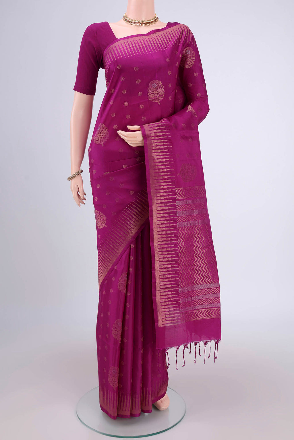 Magenta Soft Silk Saree with Zari Butta on the body and Zari Border.  displayed on a mannequin