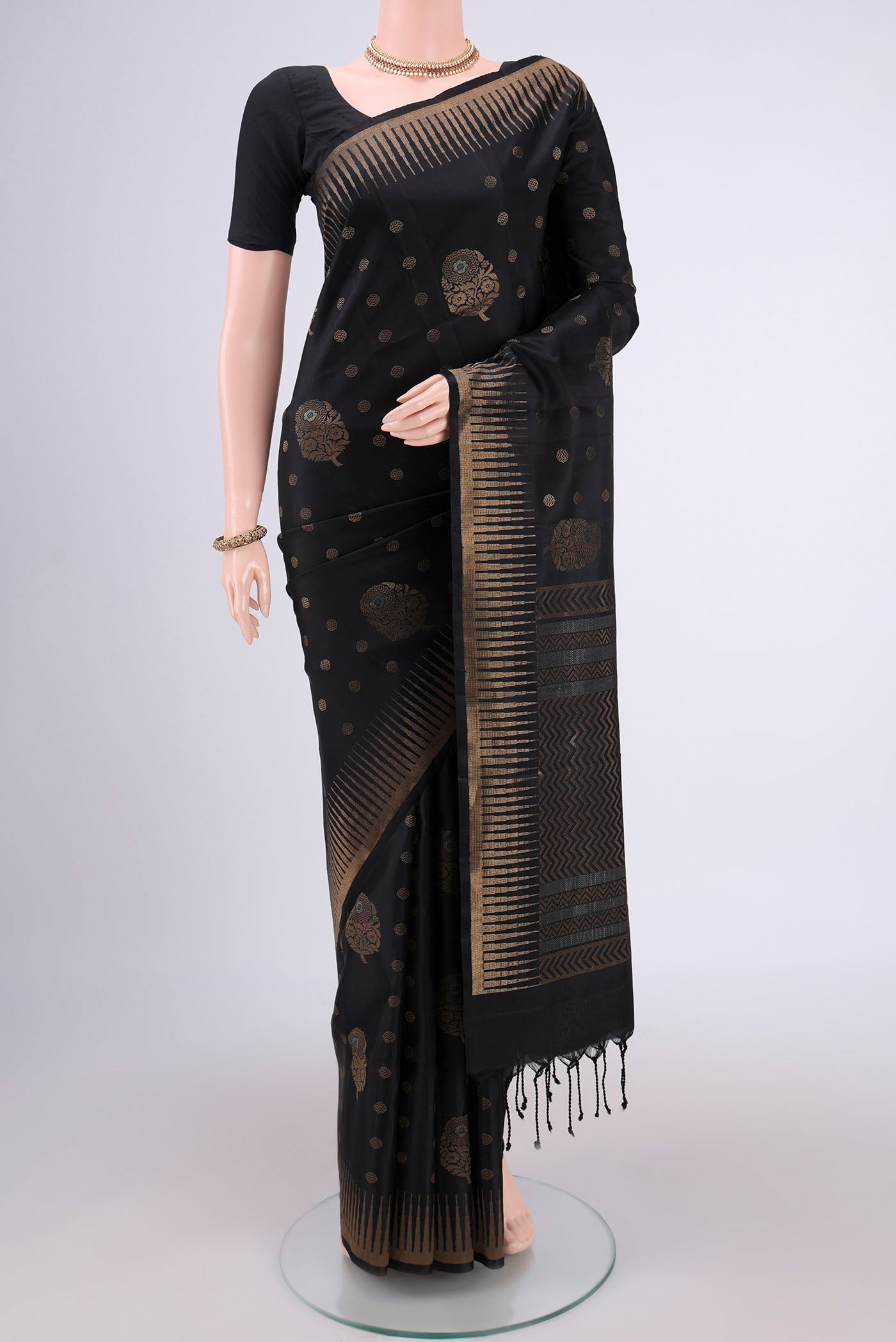 Black Baluchari Silk Saree with Zari Butta on the body and Zari Border.  displayed on a mannequin
