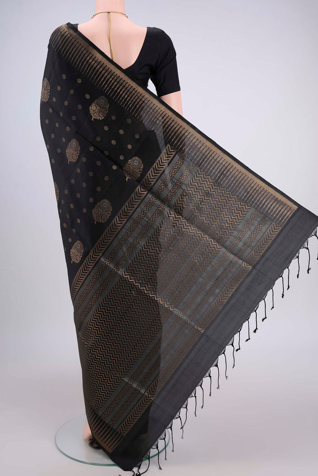 Flat view of Black Baluchari Silk Saree with Zari Butta on the body and Zari Border. 