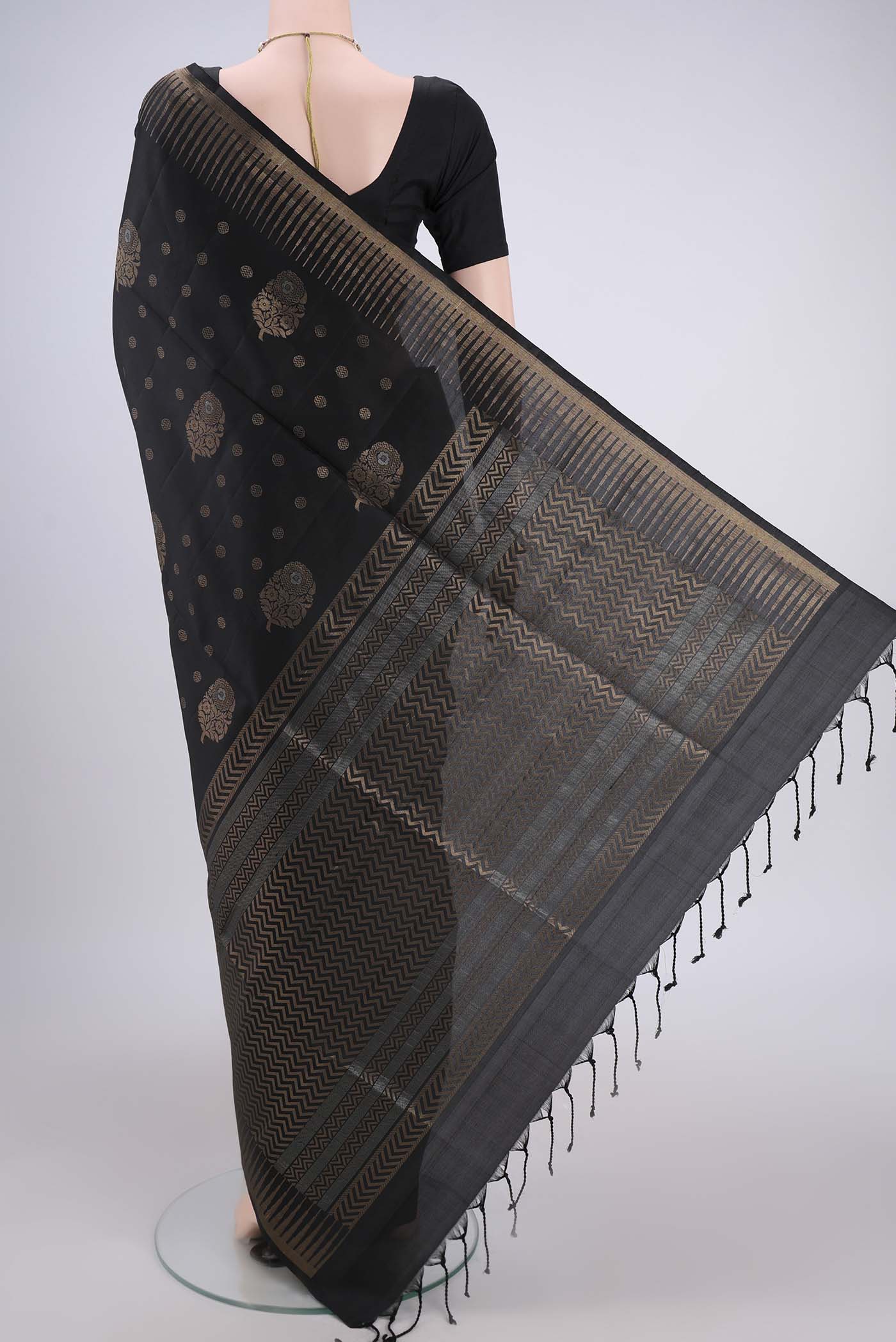 Flat view of Black Baluchari Silk Saree with Zari Butta on the body and Zari Border. 