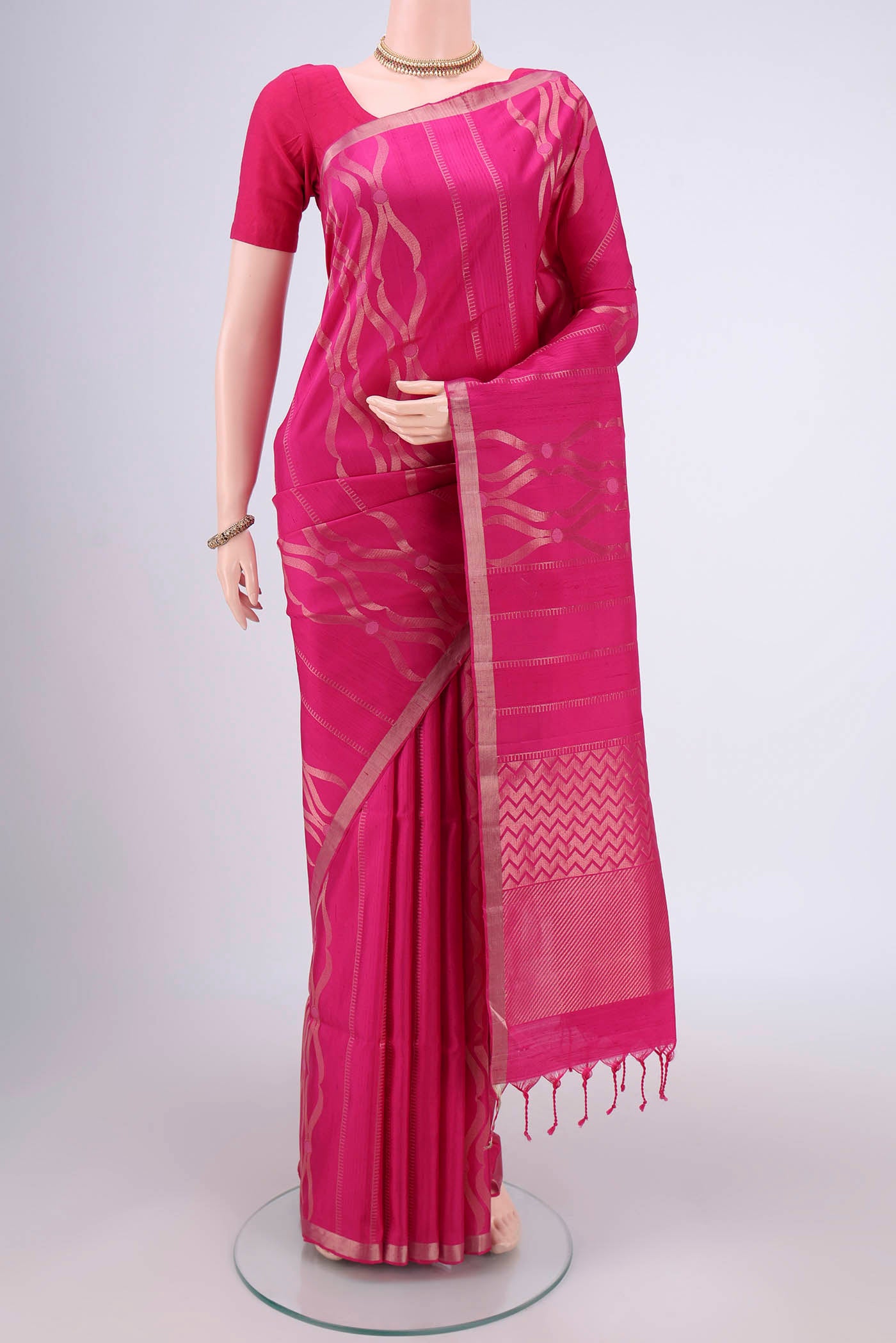 Rani Pink Soft Silk Saree with Zari Brocade on the body and Zari Border.  displayed on a mannequin