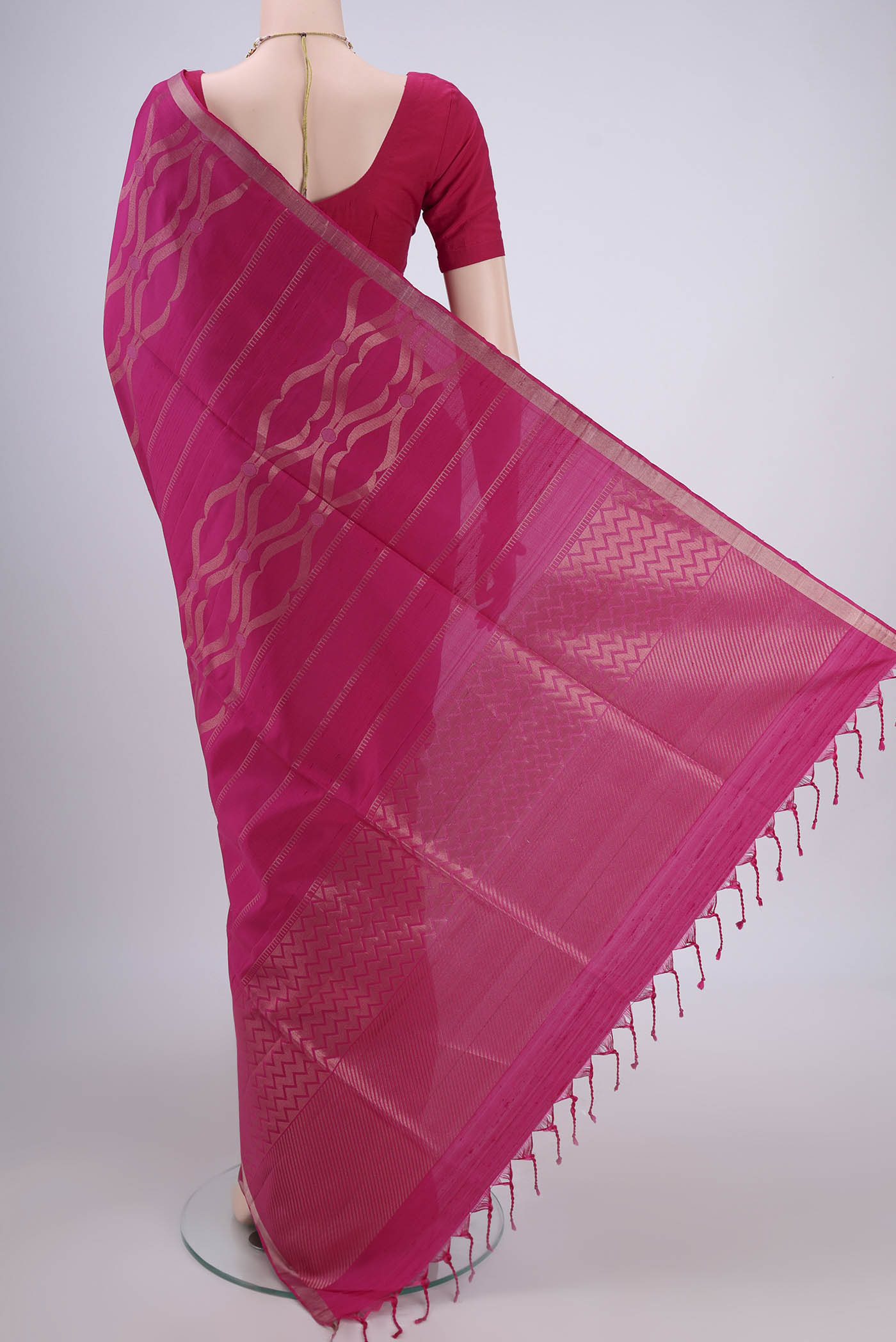 Flat view of Rani Pink Soft Silk Saree with Zari Brocade on the body and Zari Border. 