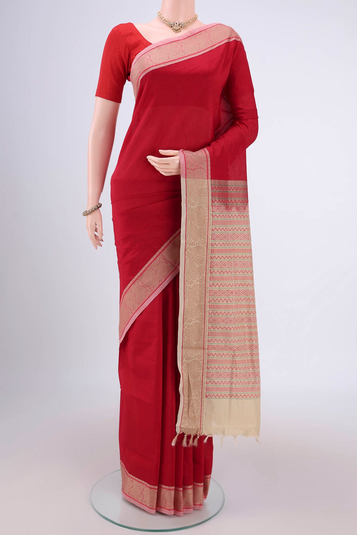 Red Blended Poly Cotton Saree with Plain Body and Thread Border.  displayed on a mannequin