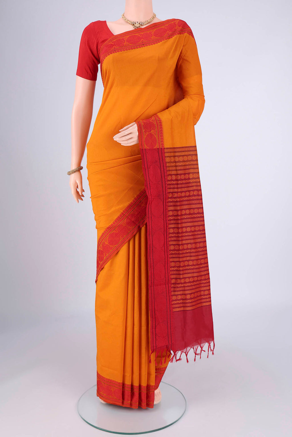 Yellow Blended Poly Cotton Saree with Plain Body and Thread Border.  displayed on a mannequin