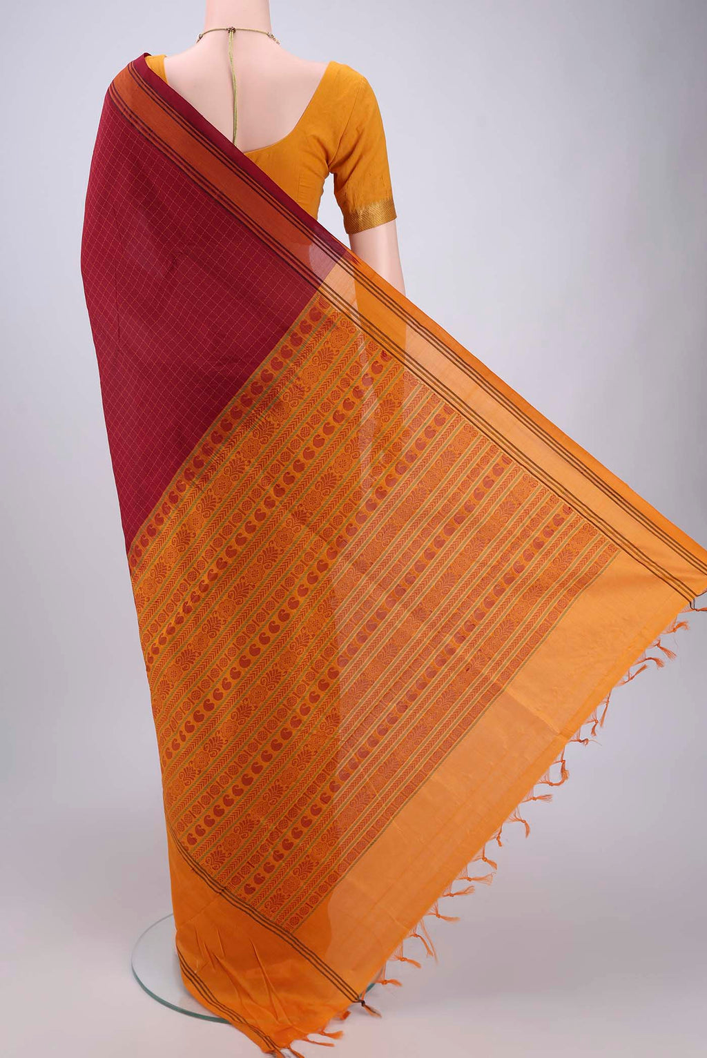 Flat view of Maroon Blended Poly Cotton Saree with Checked design on the body and Thread Border. 