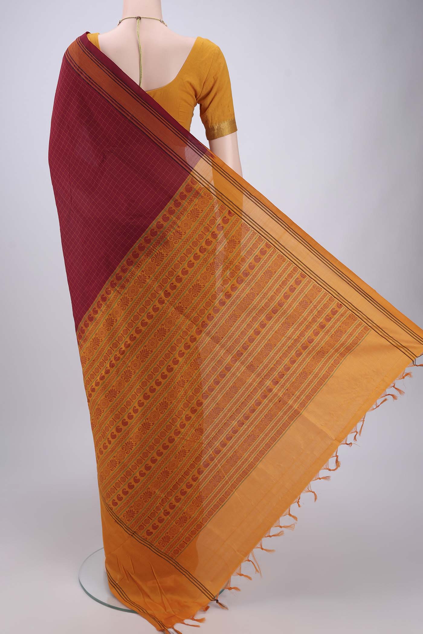 Flat view of Maroon Blended Poly Cotton Saree with Checked design on the body and Thread Border. 
