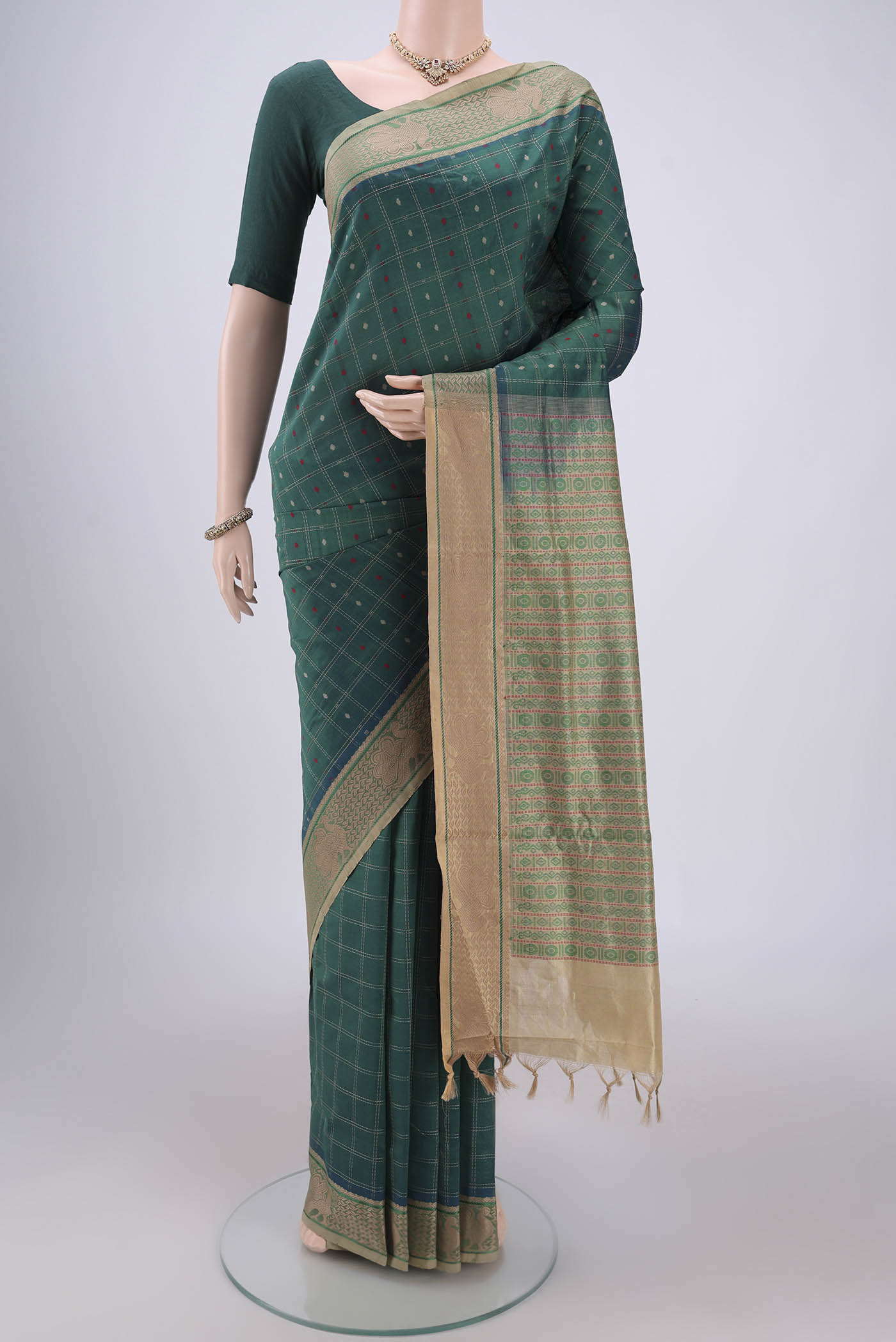 Green Blended Poly Cotton Saree with Checked design on the body and Thread Border.  displayed on a mannequin
