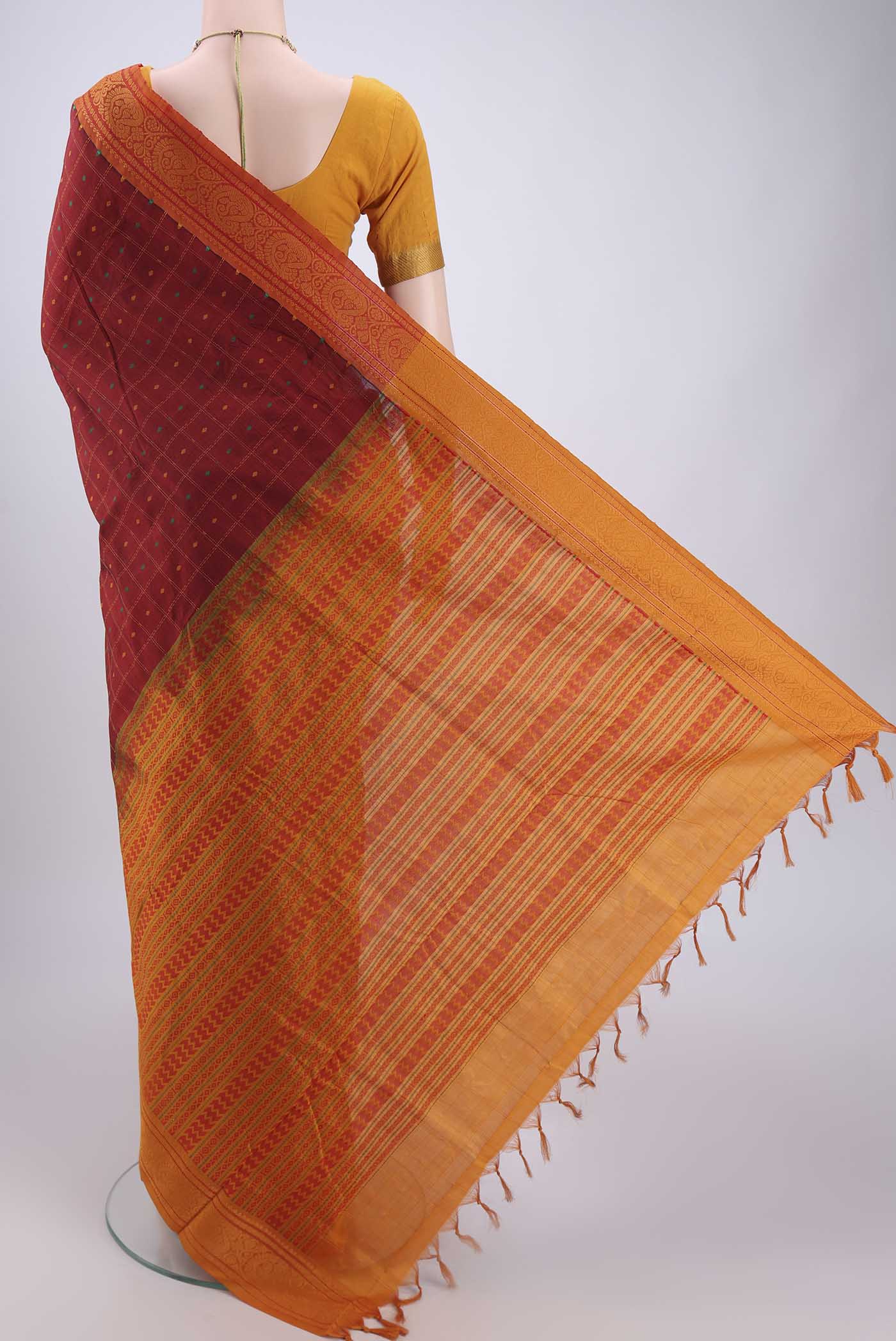 Flat view of Maroon Blended Poly Cotton Saree with Checked design on the body and Thread Border. 