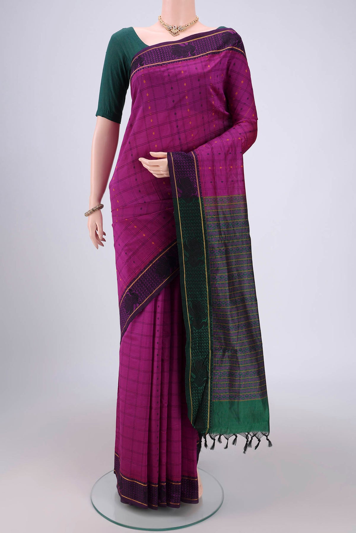Magenta Blended Poly Cotton Saree with Checked design on the body and Thread Border.  displayed on a mannequin