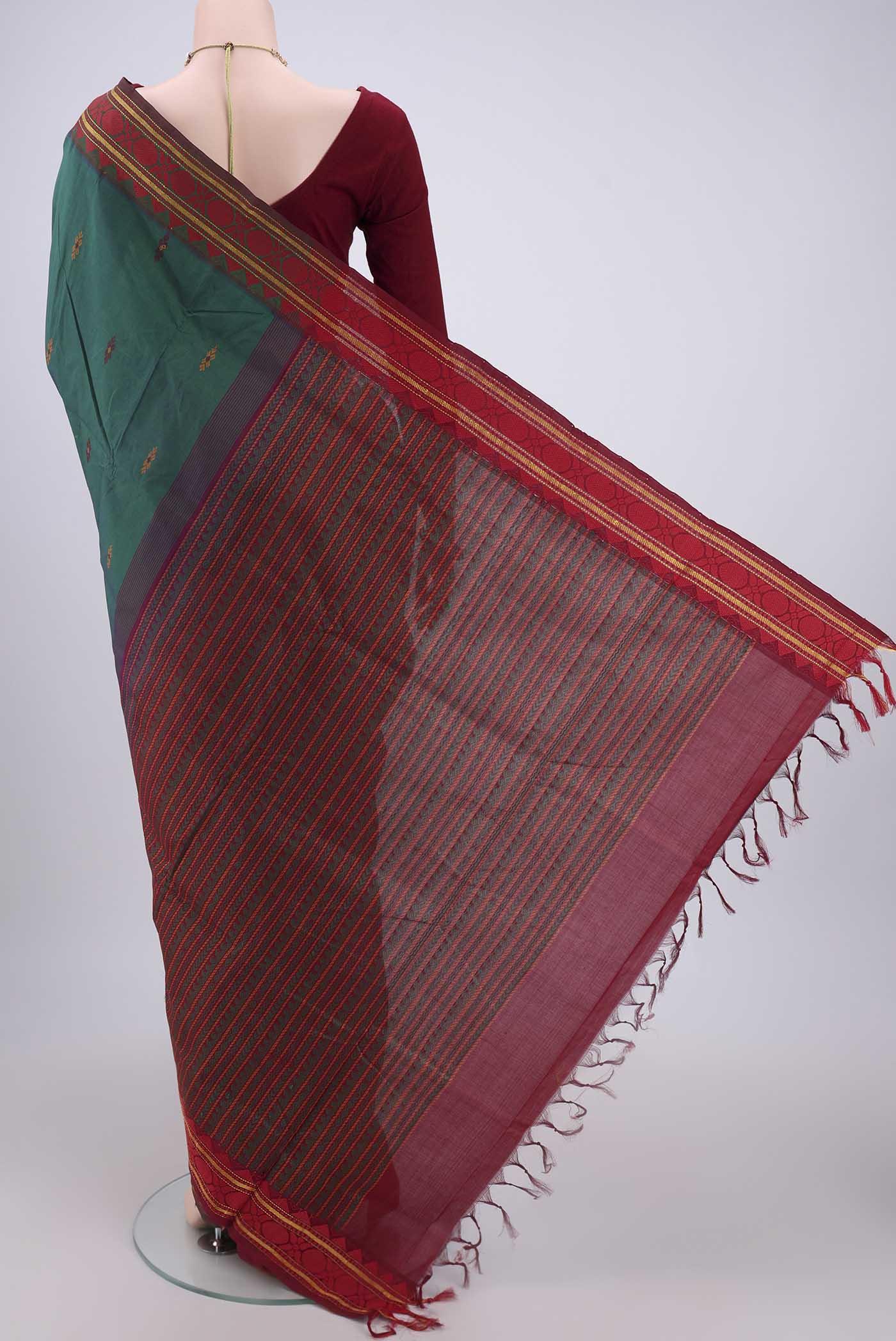 Flat view of Bottle Green Blended Poly Cotton Saree with Thread Butta on the body and Thread Border. 