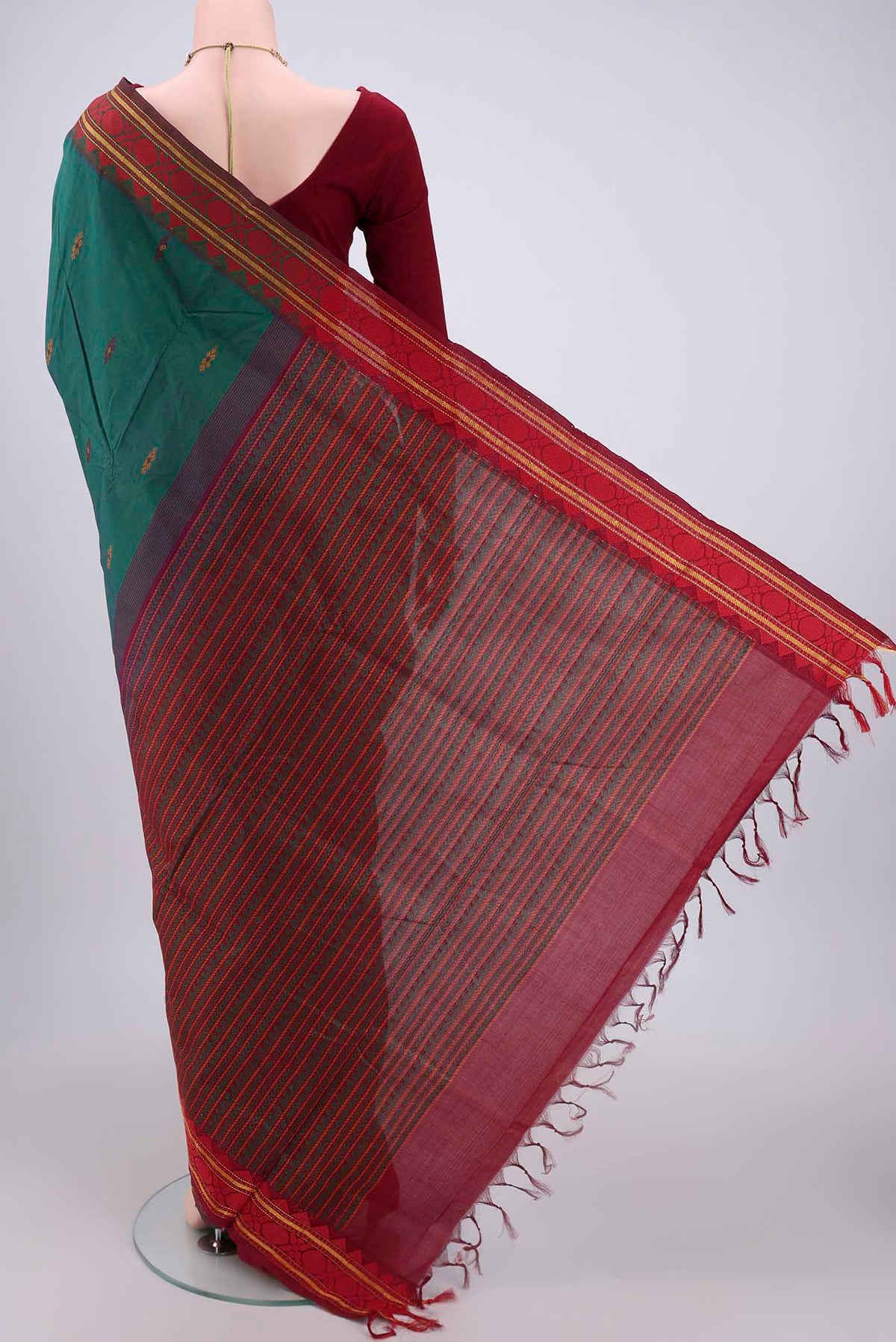 Flat view of Bottle Green Blended Poly Cotton Saree with Thread Butta on the body and Thread Border. 