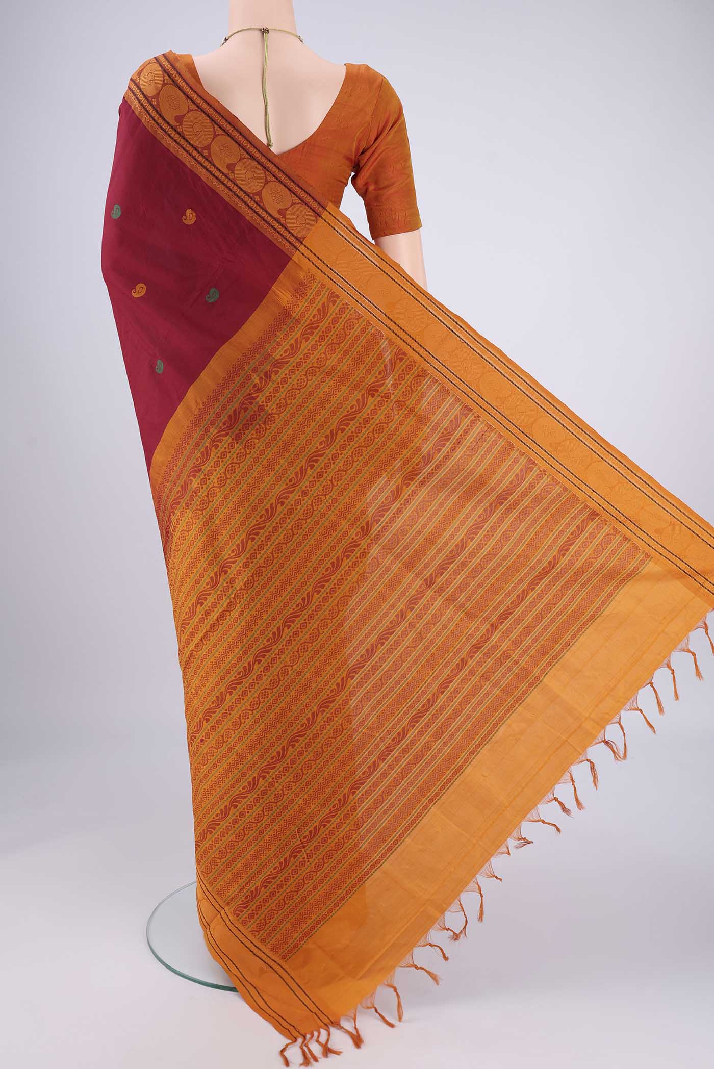 Flat view of Maroon Blended Poly Cotton Saree with Thread Butta on the body and Thread Border. 
