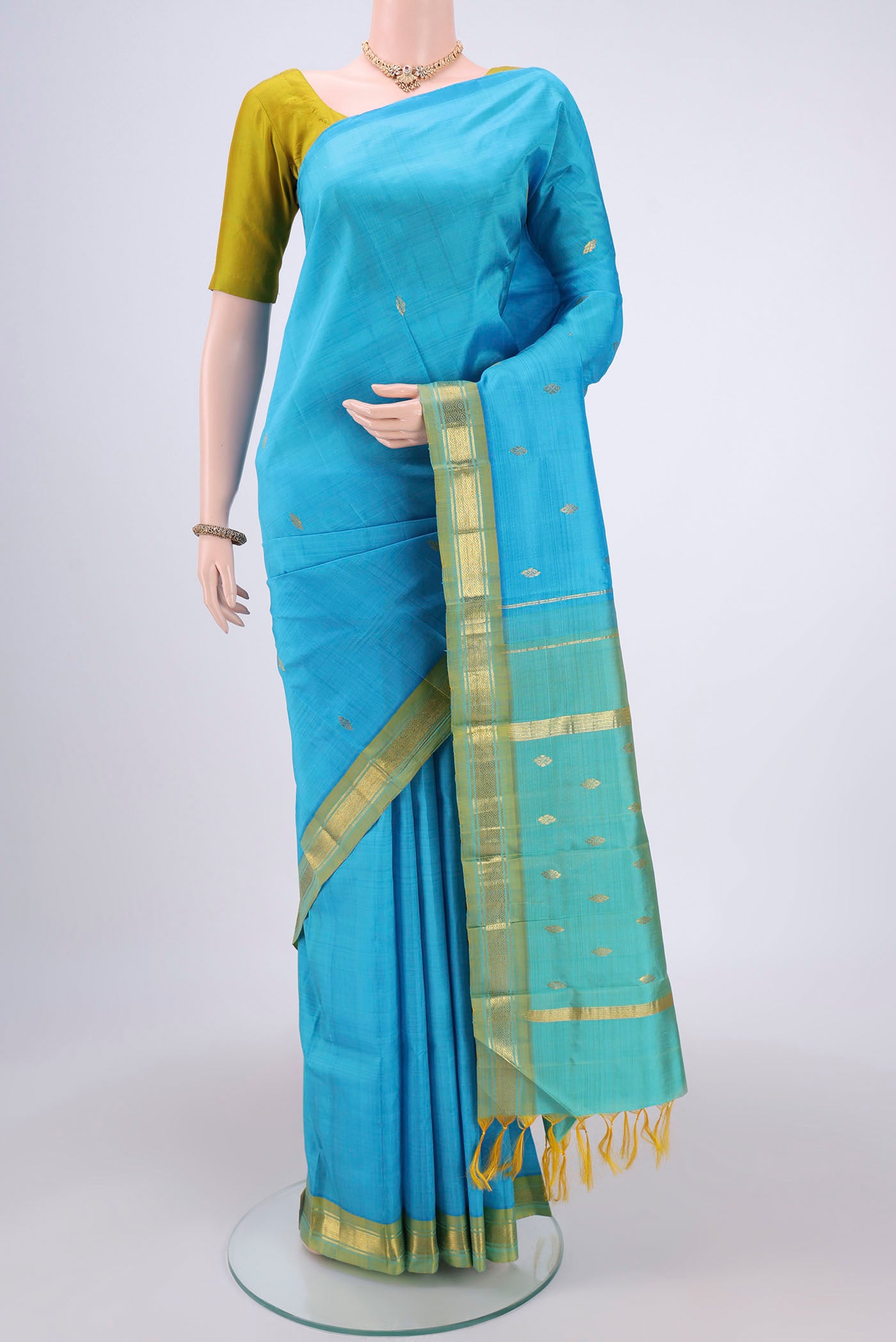 Blue Kanchipuram Silk Saree with Zari Butta on the body and One Side Border.  displayed on a mannequin