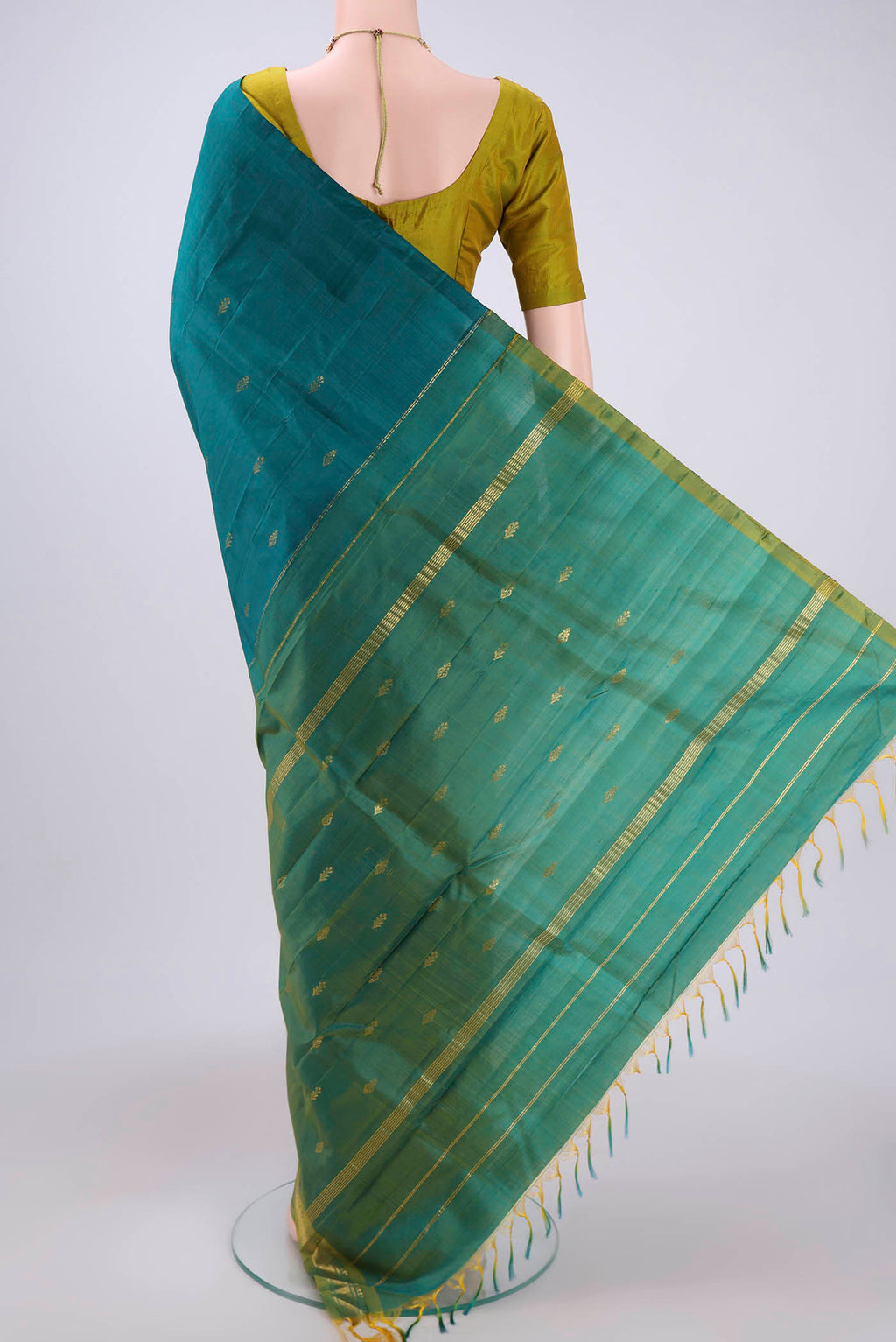 Flat view of Green Kanchipuram Silk Saree with Zari Butta on the body and One Side Border. 