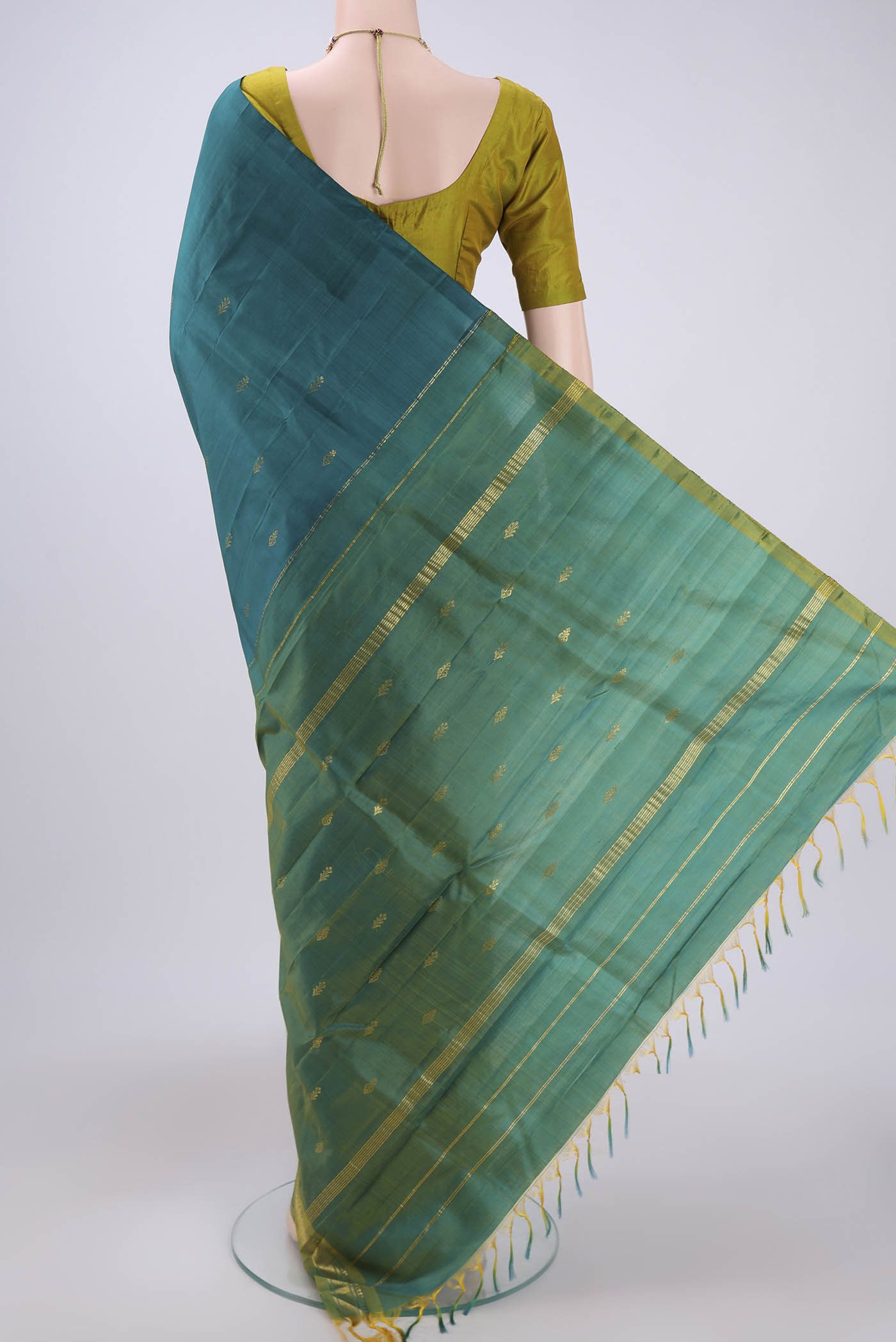 Flat view of Green Kanchipuram Silk Saree with Zari Butta on the body and One Side Border. 