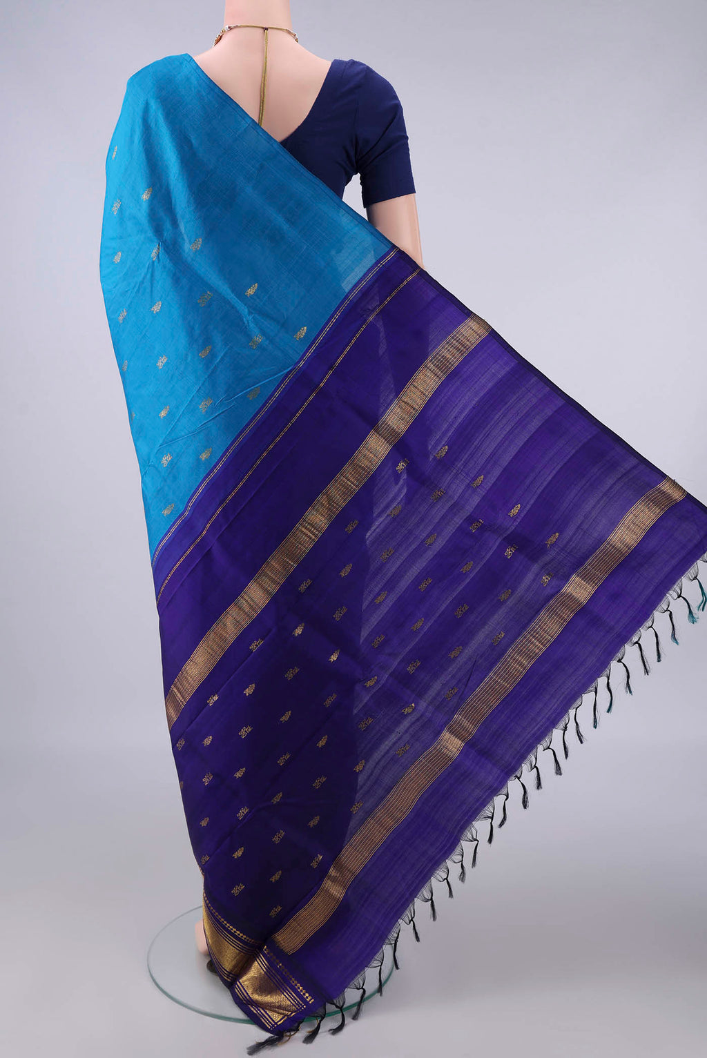 Flat view of Pure Silk Blue Kanjivaram Saree with Zari Butta on the body and Zari Border. 