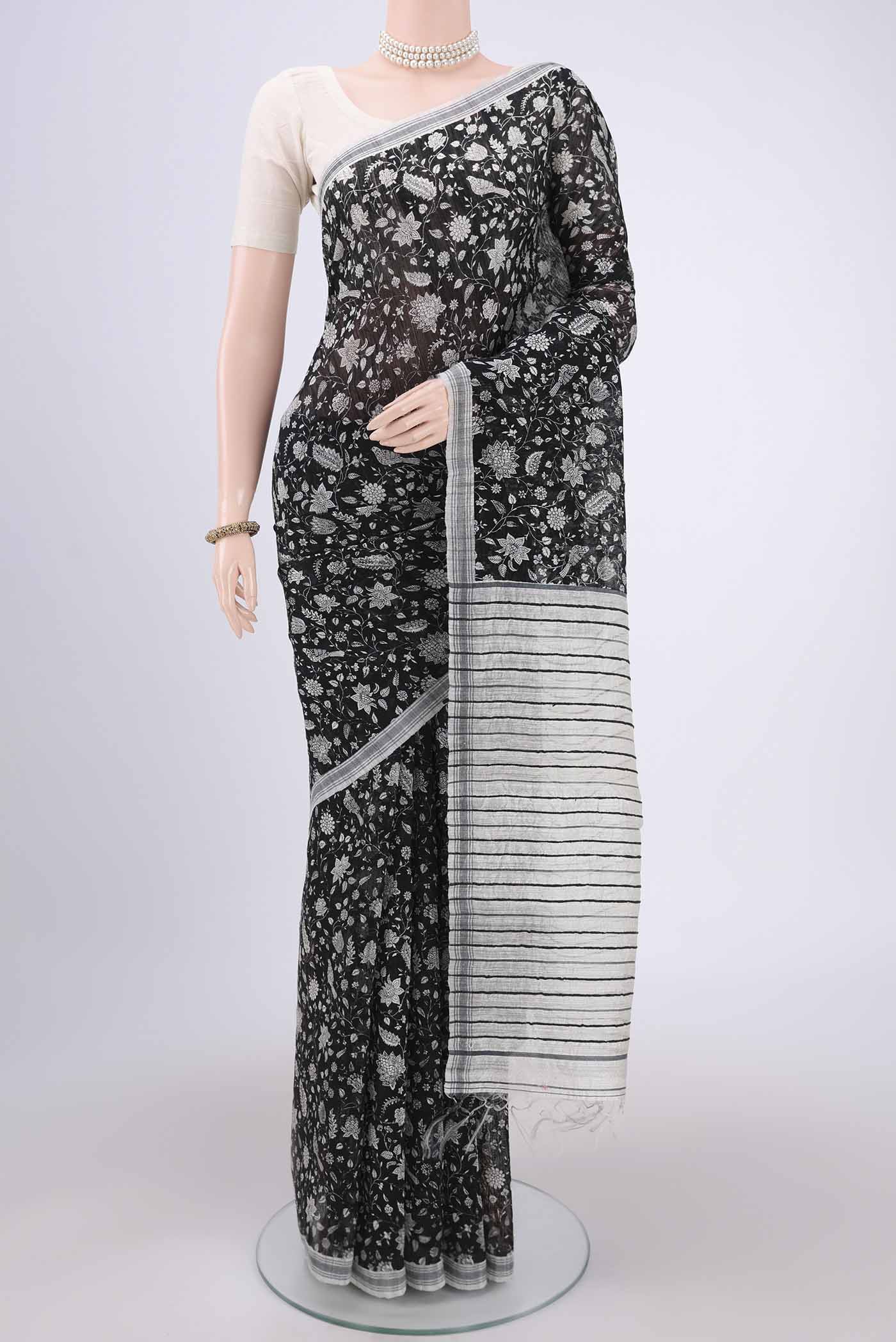 Black Tussar Silk Saree with Printed design on the body and Plain Border.  displayed on a mannequin