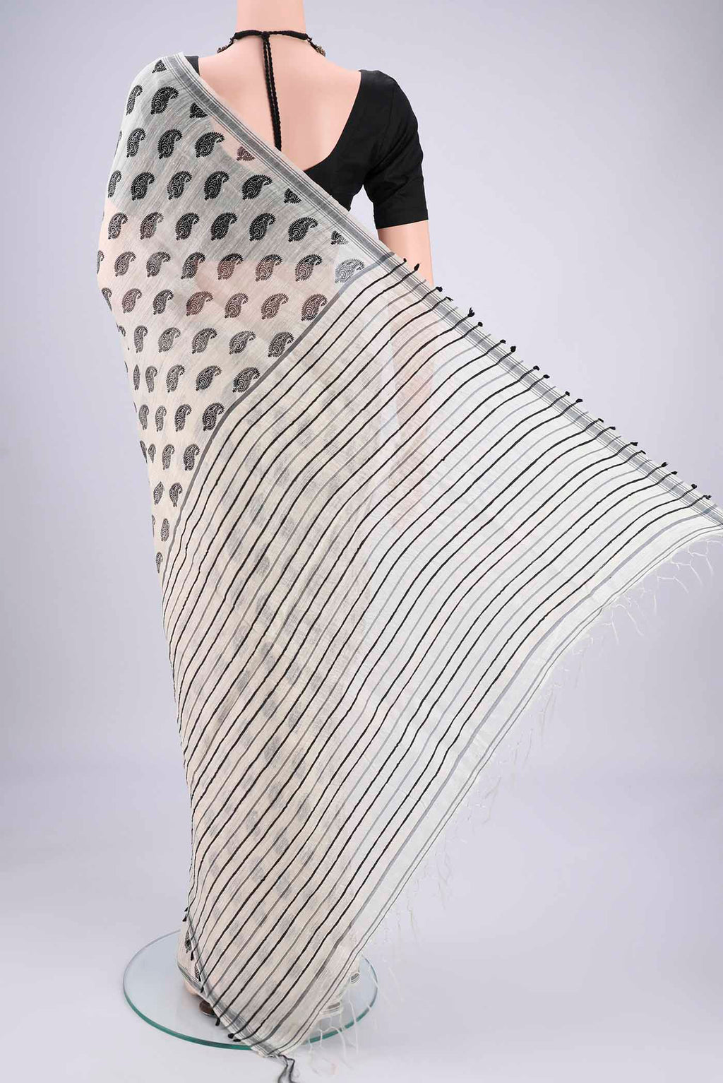 Flat view of Off White Tussar Silk Saree with Printed design on the body and Plain Border. 