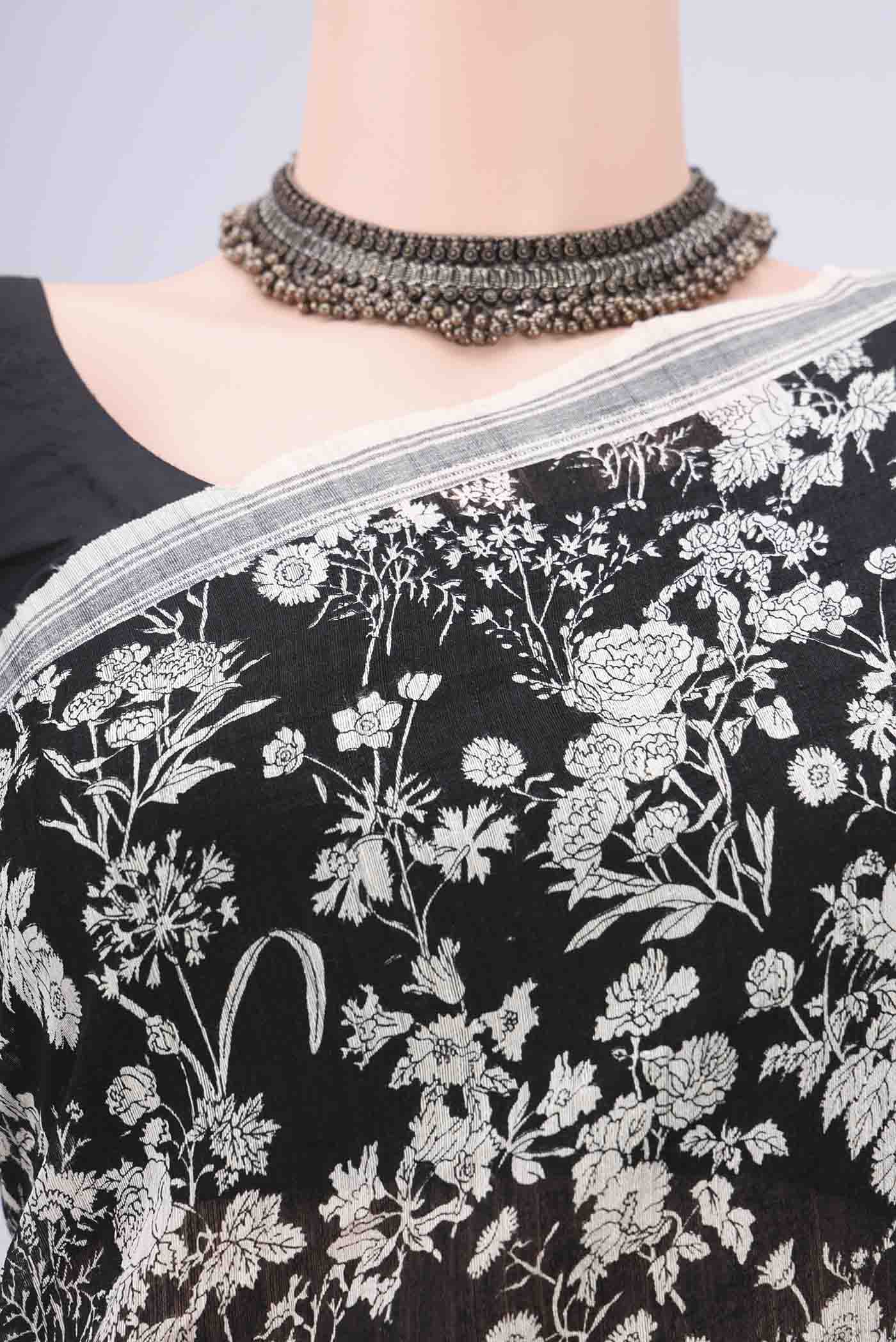 Border image of Black Tussar Silk Saree with Printed design on the body and Plain Border. 