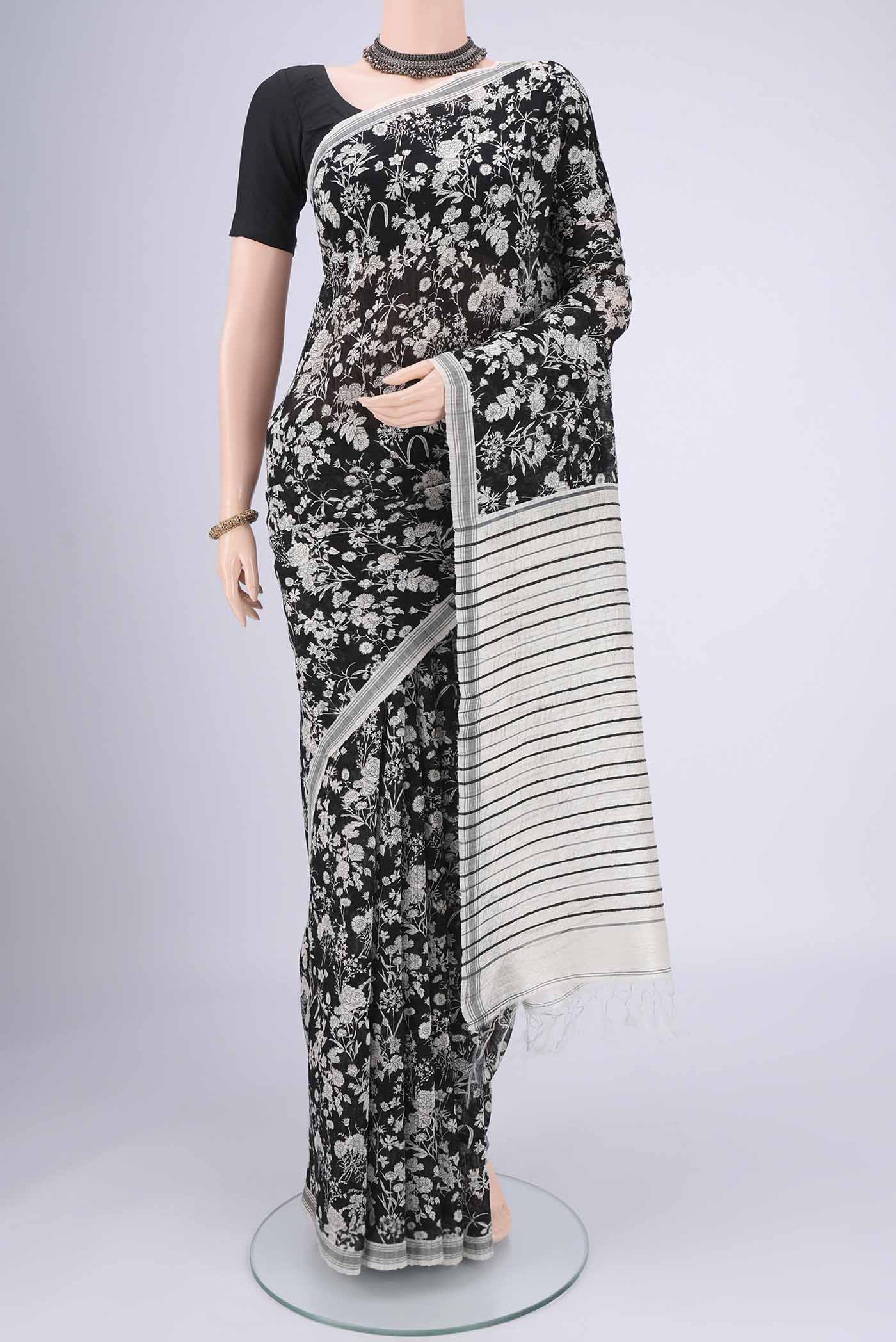 Black Tussar Silk Saree with Printed design on the body and Plain Border.  displayed on a mannequin