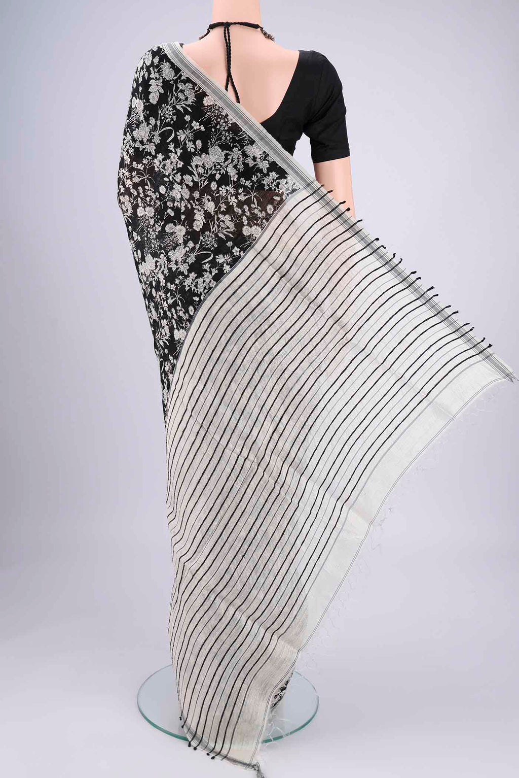 Flat view of Black Tussar Silk Saree with Printed design on the body and Plain Border. 