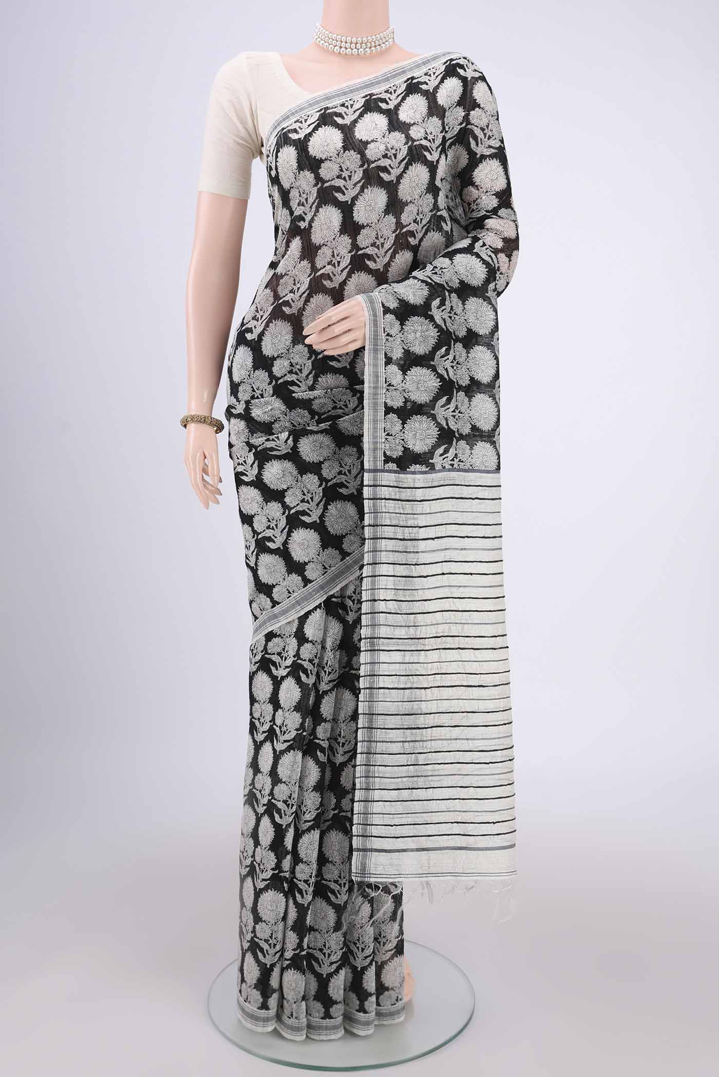 Black Tussar Silk Saree with Printed design on the body and Plain Border.  displayed on a mannequin