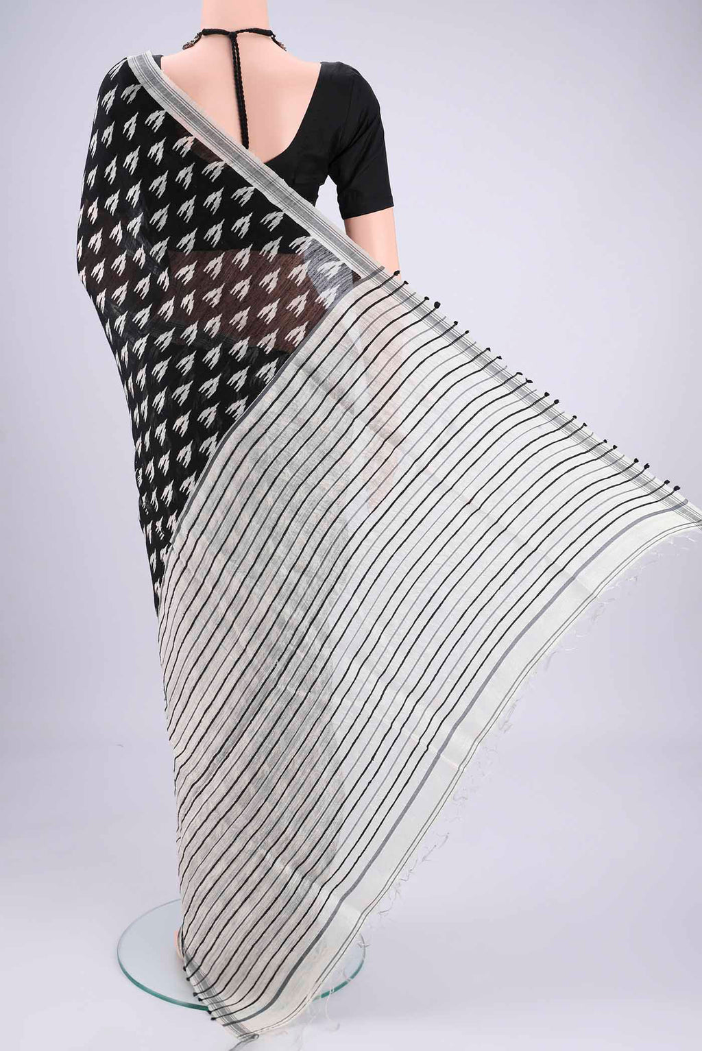 Flat view of Black Tussar Silk Saree with Printed design on the body and Plain Border. 