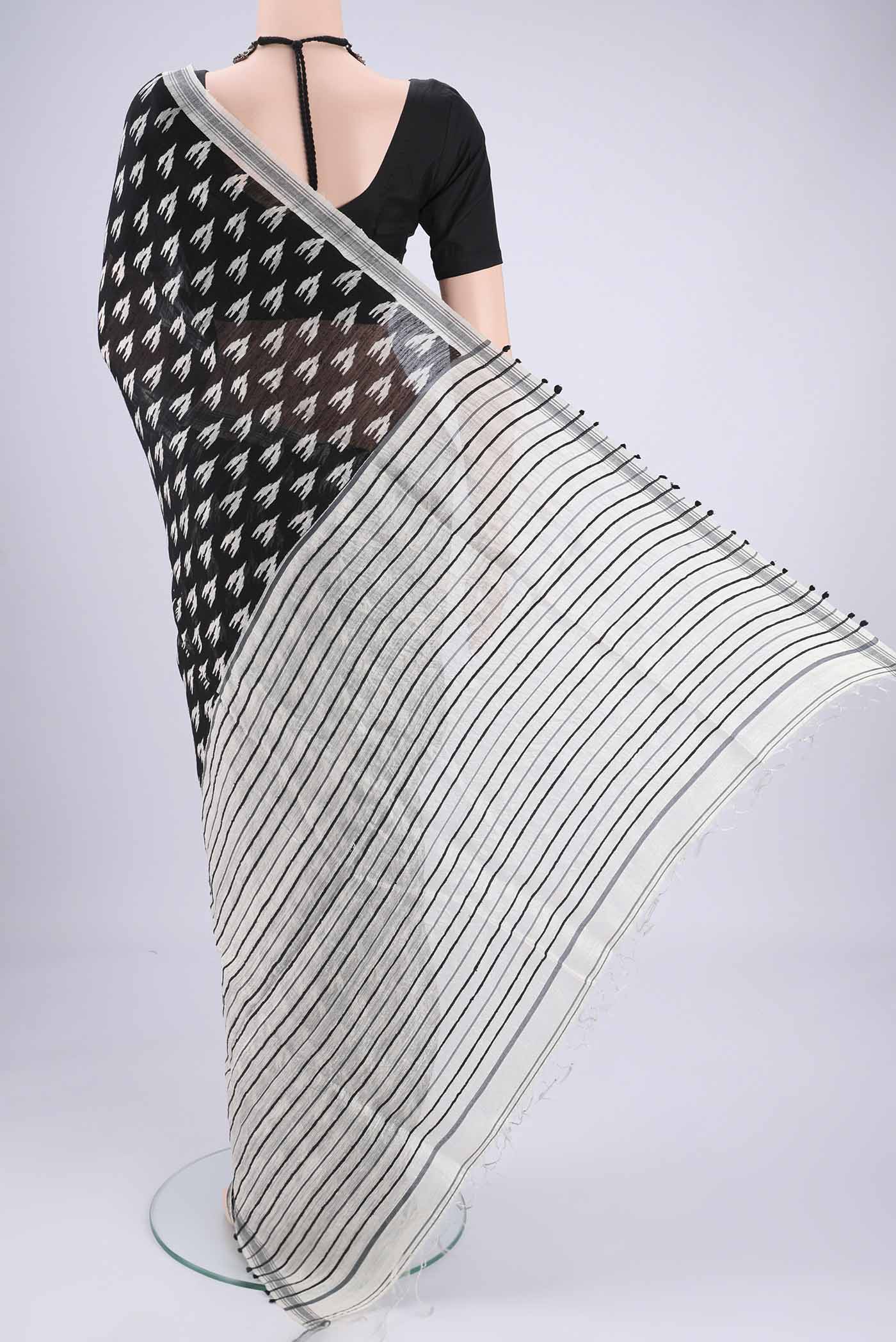 Flat view of Black Tussar Silk Saree with Printed design on the body and Plain Border. 